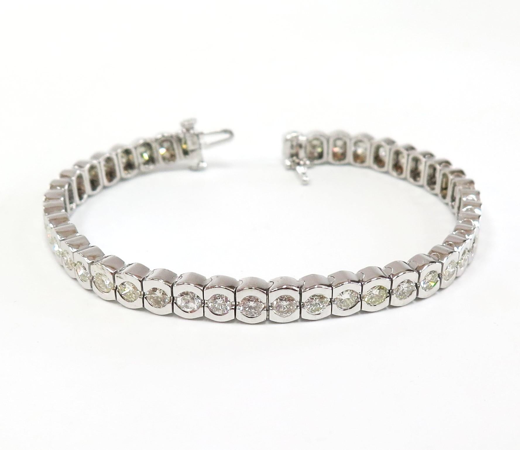 Beautiful 6.30 Carat total Diamond Weight tennis bracelet in unique scalloped 14 karat white gold setting. 

Diamonds: Color: Near Colorless, Clarity: VS/SI.
7 Inches in length
Tight lock with underneath safety.