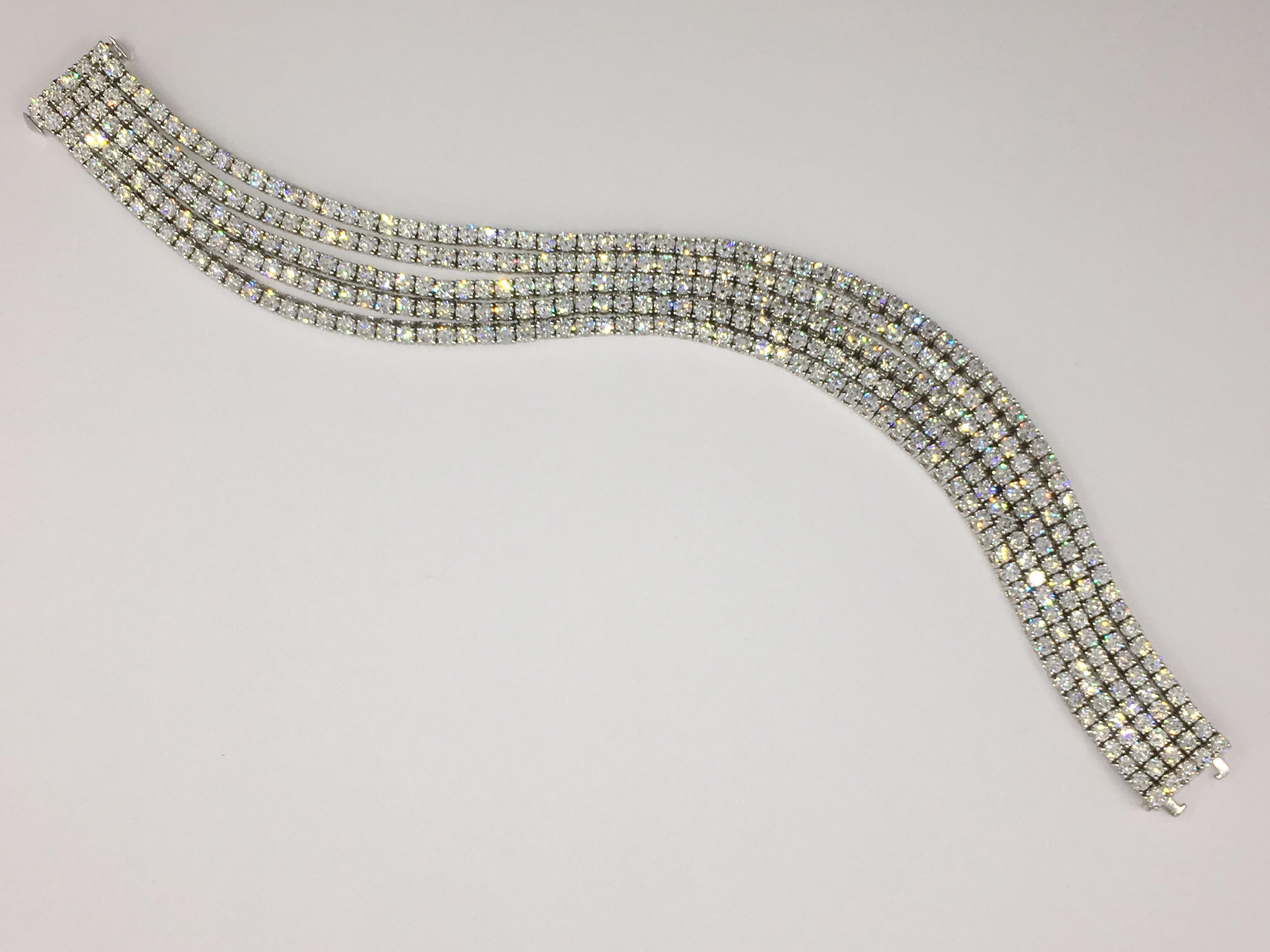 5 strand tennis bracelet with round diamonds in 4 prong setting on 18kt White gold.