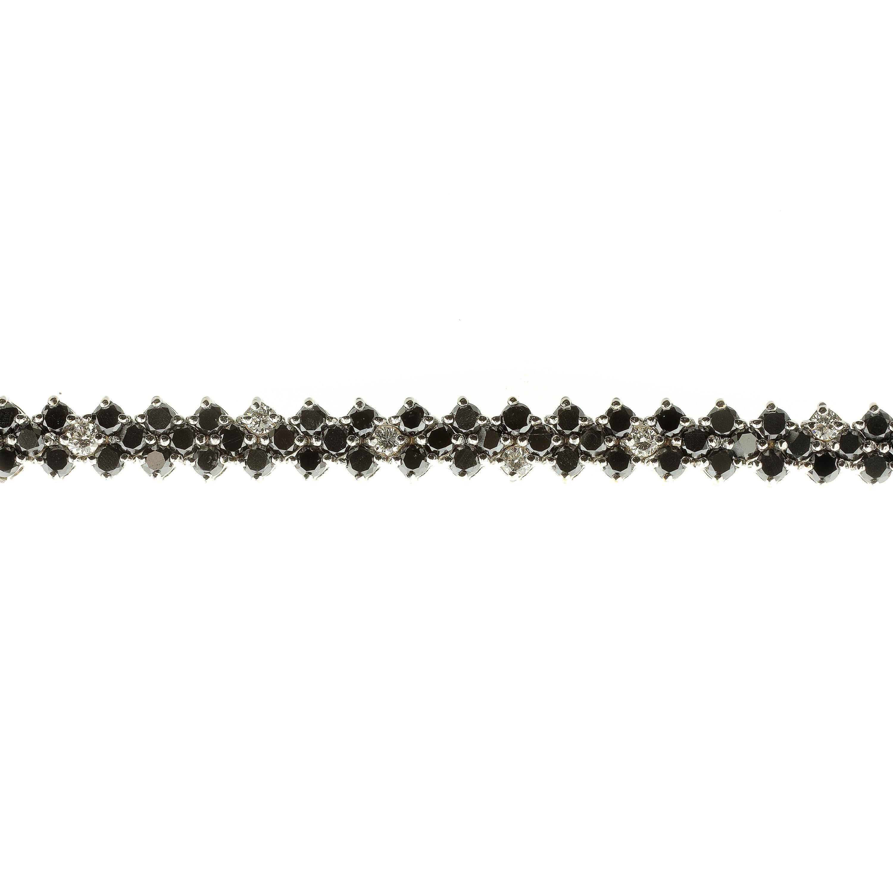This tennis bracelet is a gorgeous accessory for any day of the week. Made from 18-karat white gold and set with white diamonds rated F/G VVS and 4.26-carats of black diamonds. This is a wonderful take on the original style of diamond tennis