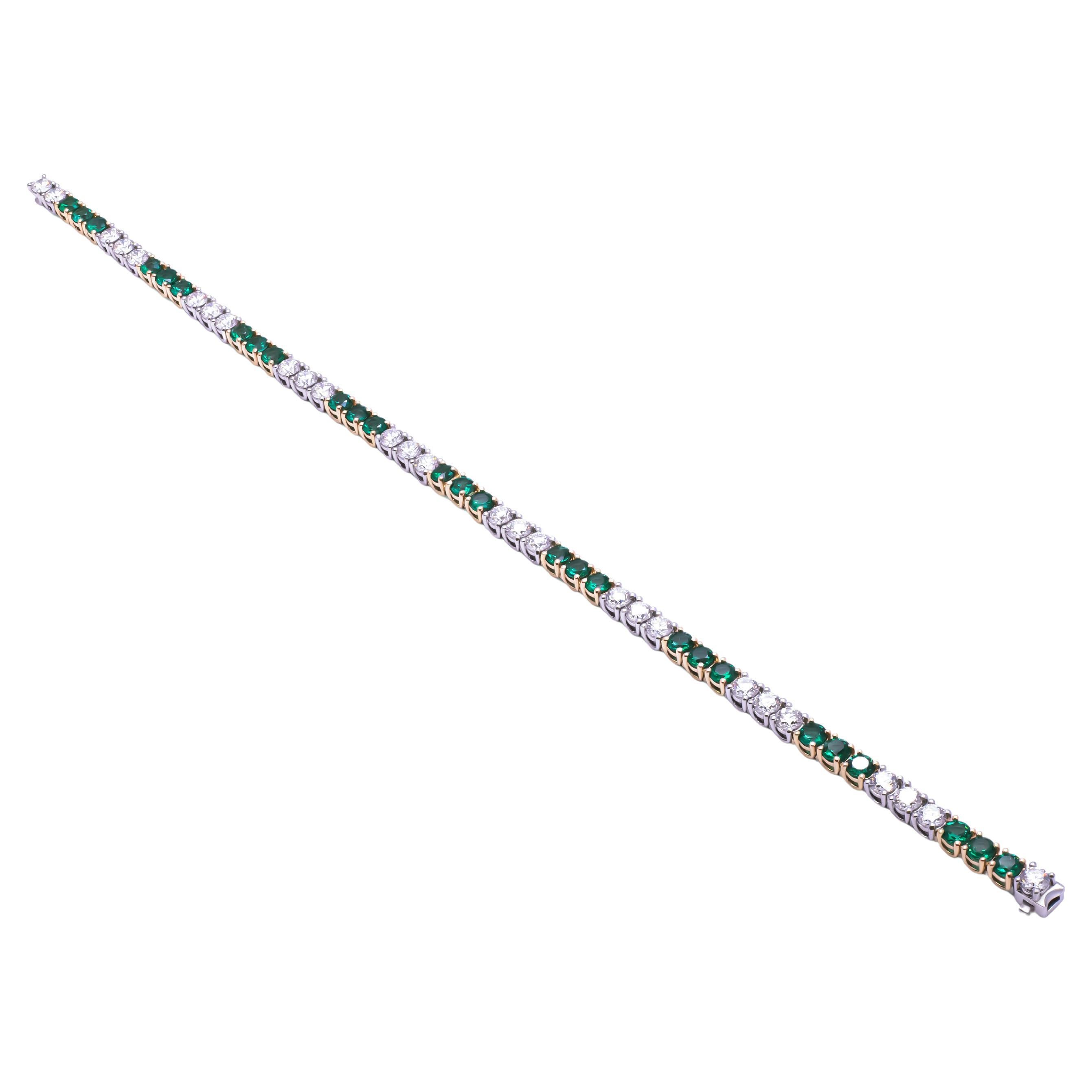 Introducing the epitome of timeless elegance, the Tennis Bracelet in 18K Yellow Gold and Platinum adorned with exquisite green emeralds and dazzling diamonds. This meticulously crafted bracelet seamlessly combines opulence and sophistication to
