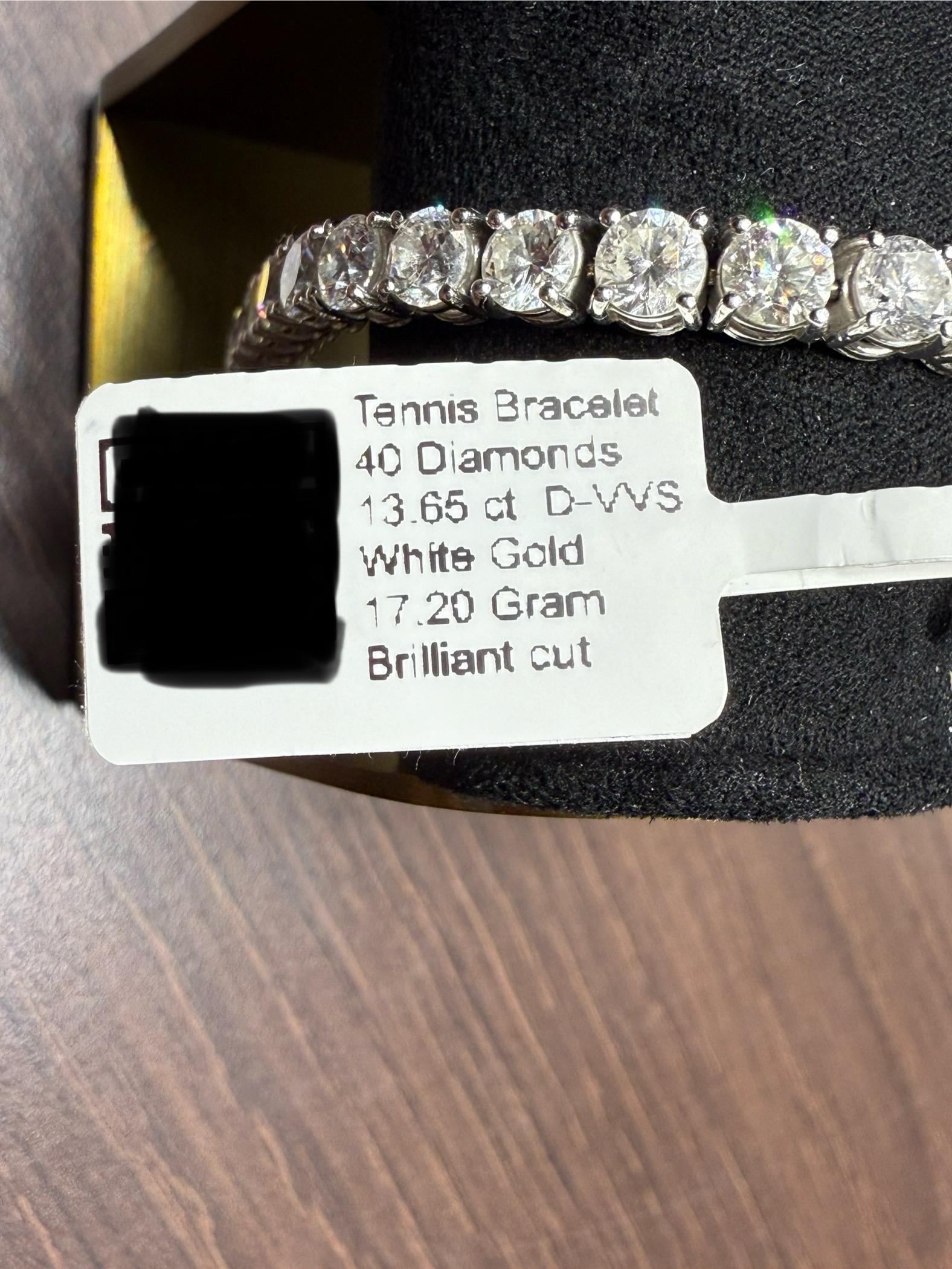 This luxurious Tennis Bracelet is a dazzling masterpiece, crafted in white gold and adorned with 13.65 carats of exceptional natural diamonds. The bracelet features 40 brilliant-cut natural diamonds, prong-set, each meticulously selected for its