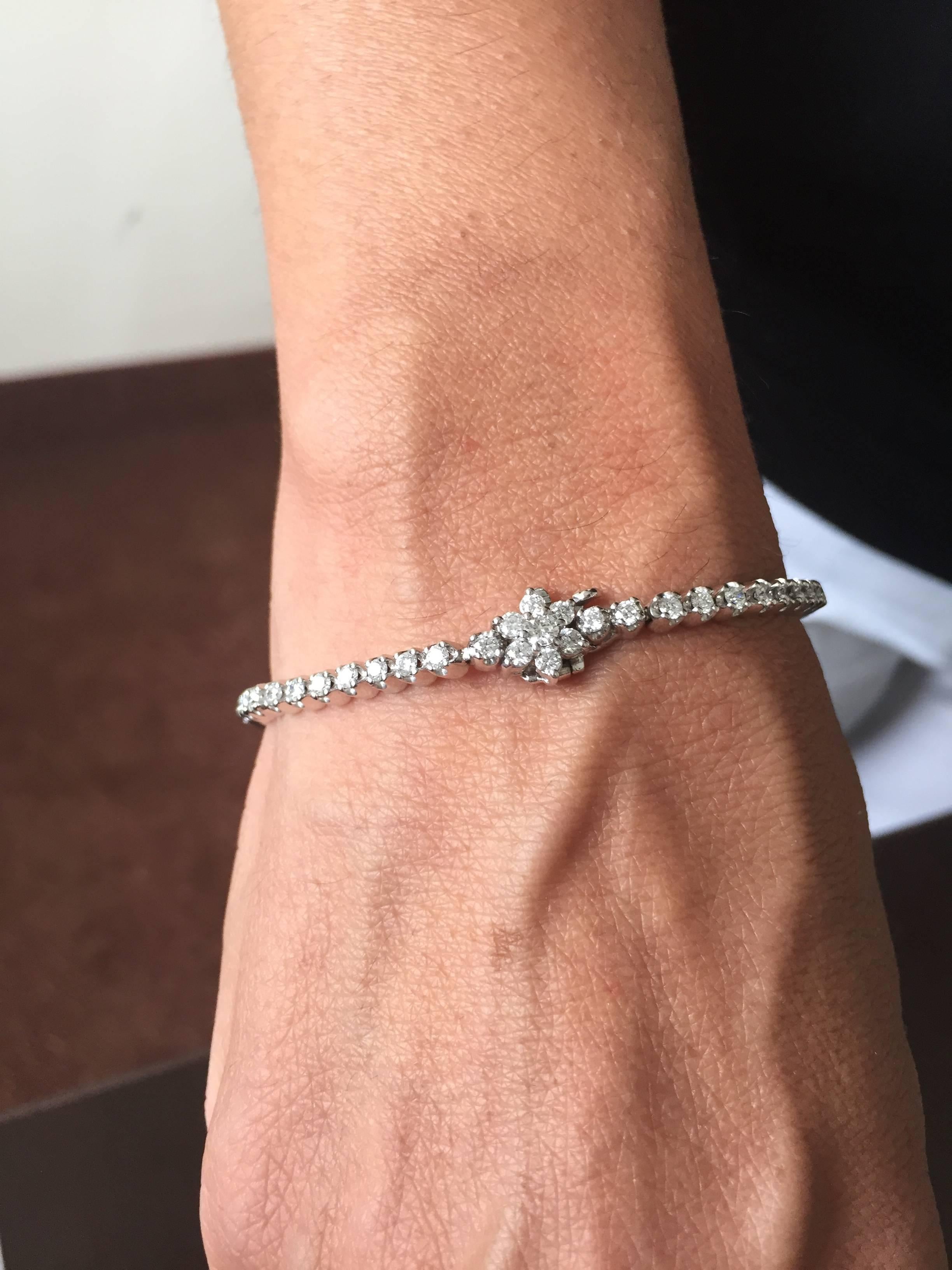 This elegant Tennis Bracelet is tied together with a unique flower clasp. The flower clasp is truly a statement turning an ordinary Tennis Bracelet into something very special.