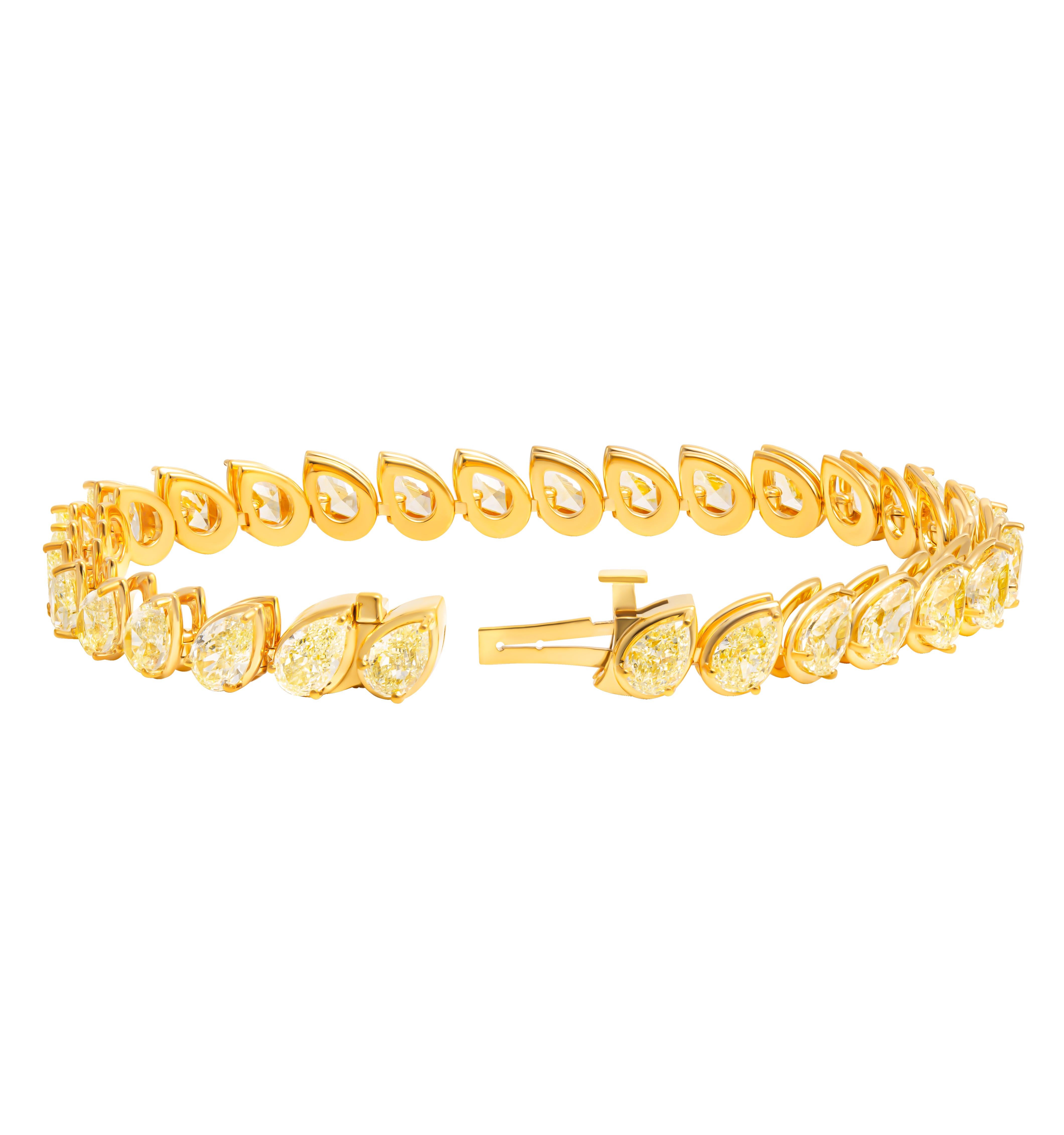 Tennis Bracelet with Fancy Light Yellow Pear Shape Diamonds
In 18K Yellow Gold with fancy light yellow  pear shapes. 
Pear shapes are slightly tilted set in pillow bezel
Length: 7” 
0.50ct each - 30 stones totaling 15.91CT                        

