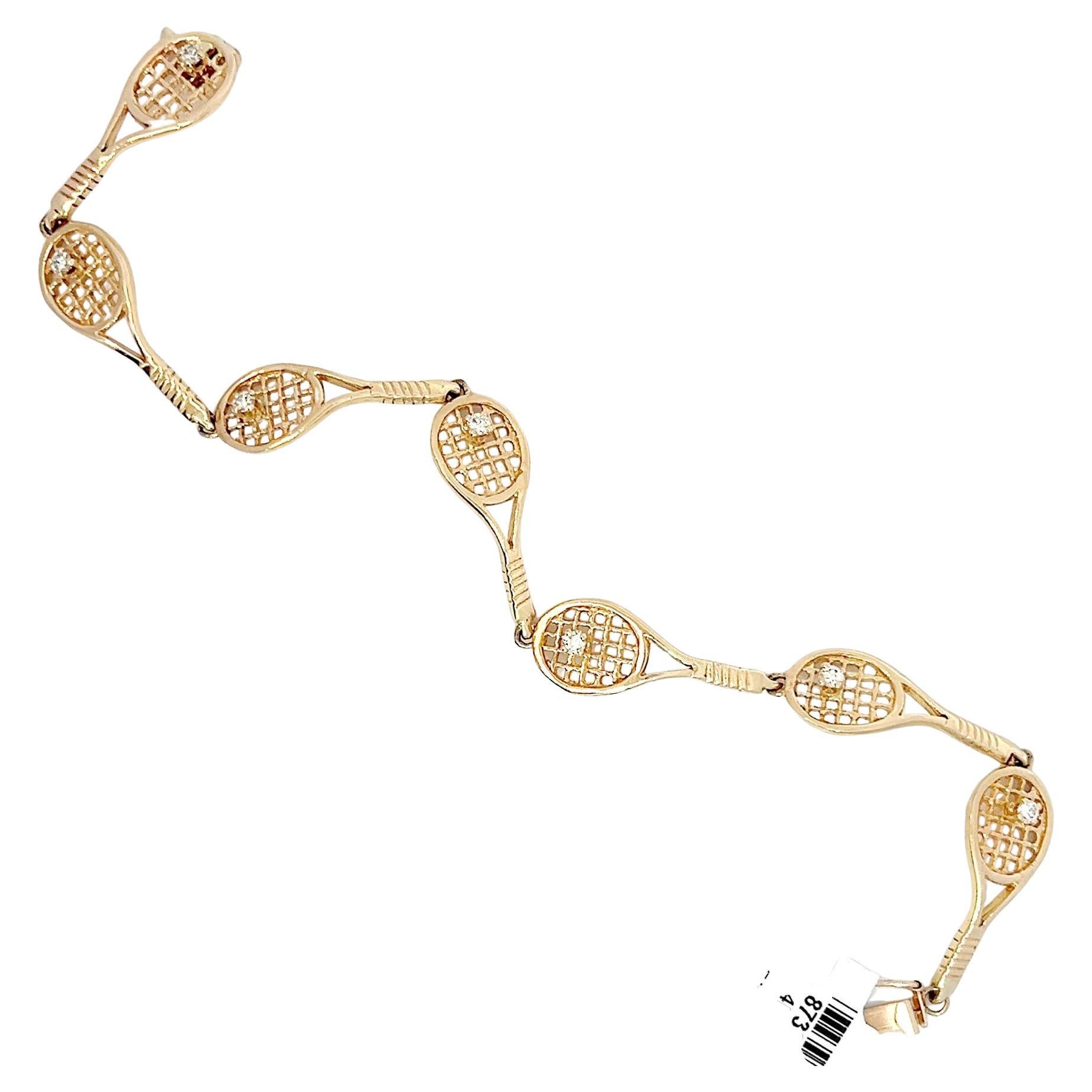 This tennis racket bracelet is a must-have for sports enthusiasts and fashion-forward individuals. It is expertly crafted in 14k yellow gold and features seven intricate tennis racket designs, each seamlessly connected head-to-handle for a total