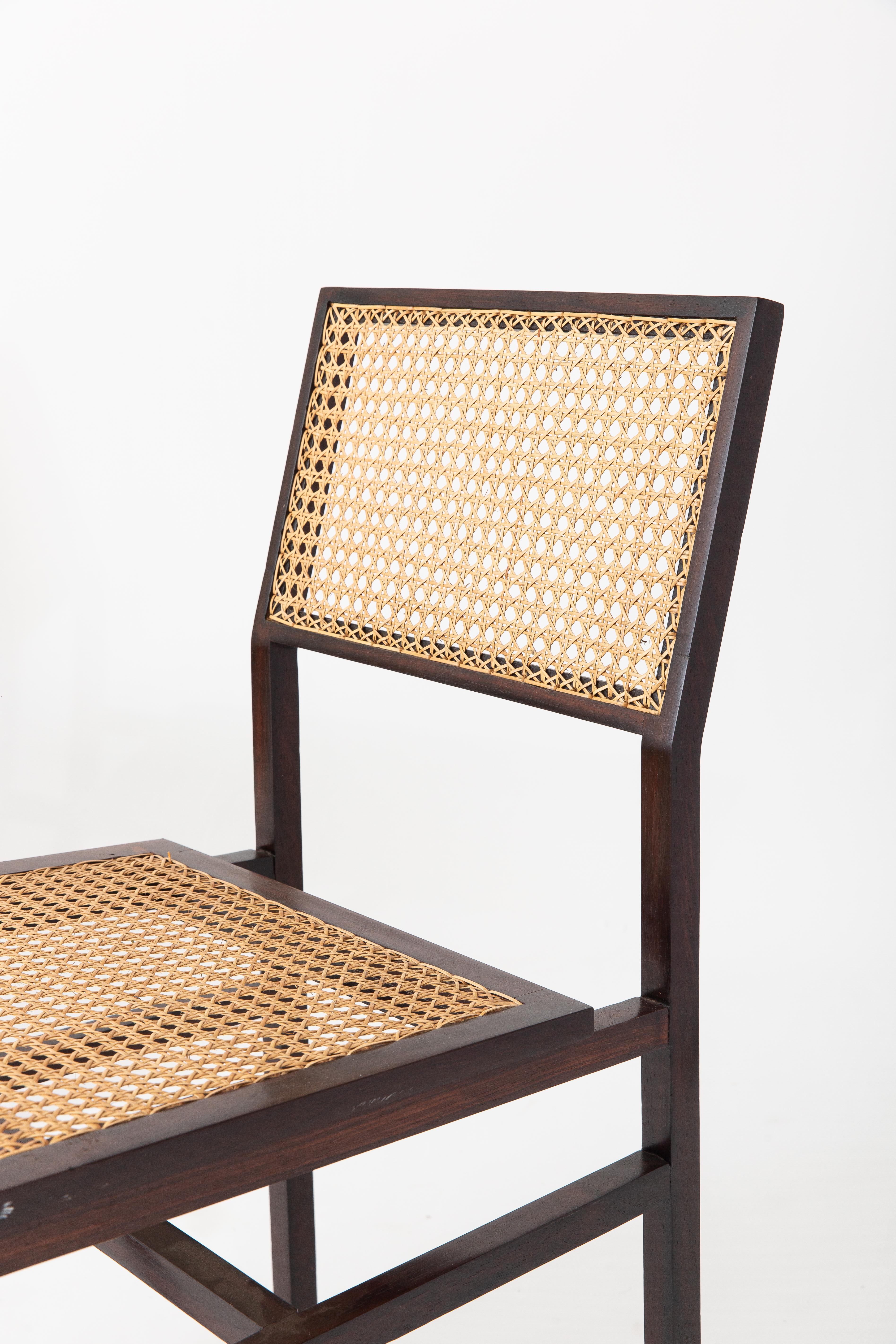 Beautiful pair of vintage Brazilian wood and woven palinha chairs from Tenreiro Arquitetura with original label on one of the chairs. 