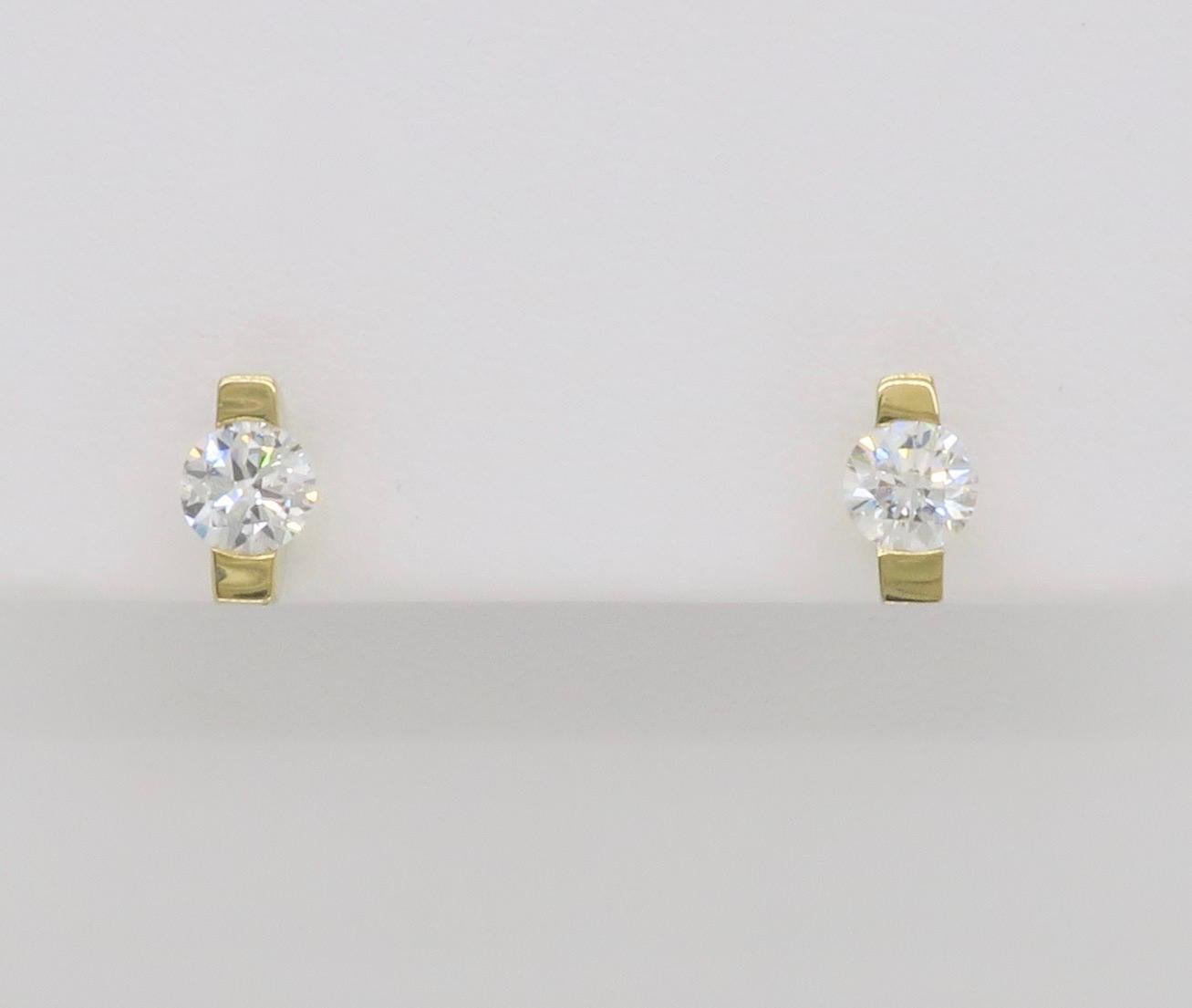 Modern tension set diamond stud earrings made in 14k yellow gold. 

Total Diamond Carat Weight: 0.65CTW
Diamond Cut: Round Brilliant Cut 
Diamond Color: F-G
Diamond Clarity: VS
Metal: 14k Yellow Gold
Stamped: 