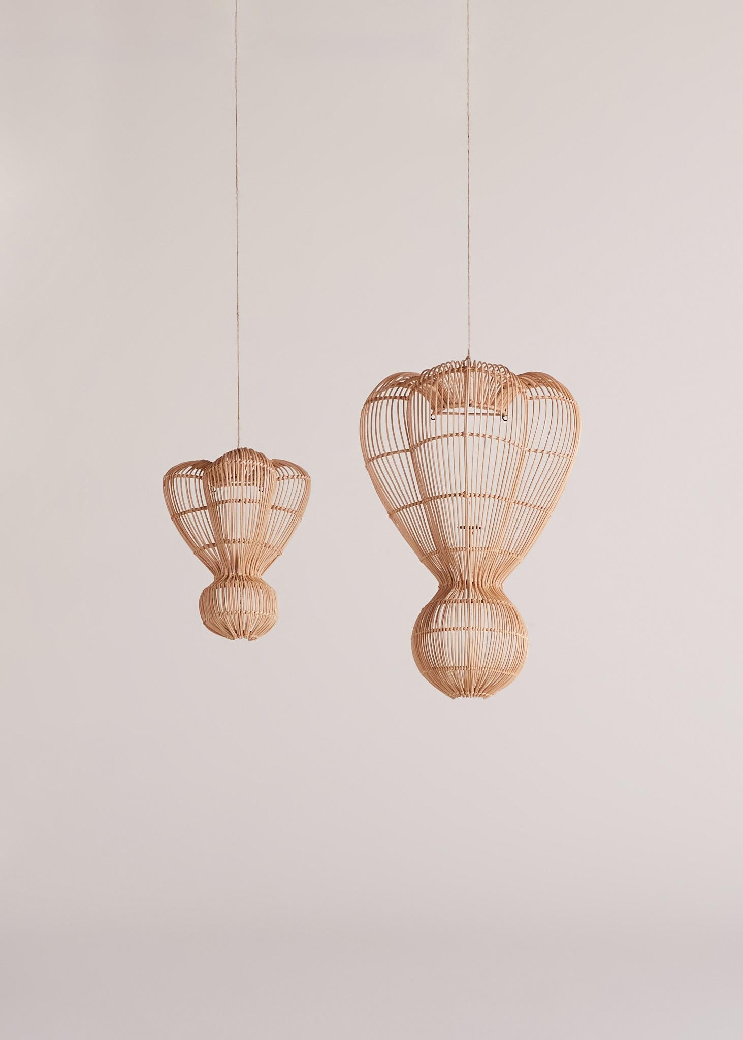 The Teo Wall Lamp is a handwoven, natural rattan wall lamp that combines organic beauty with functional design. Its smooth, curved shape creates an elegant silhouette, casting intricate patterns of light that add warmth and texture to any space.