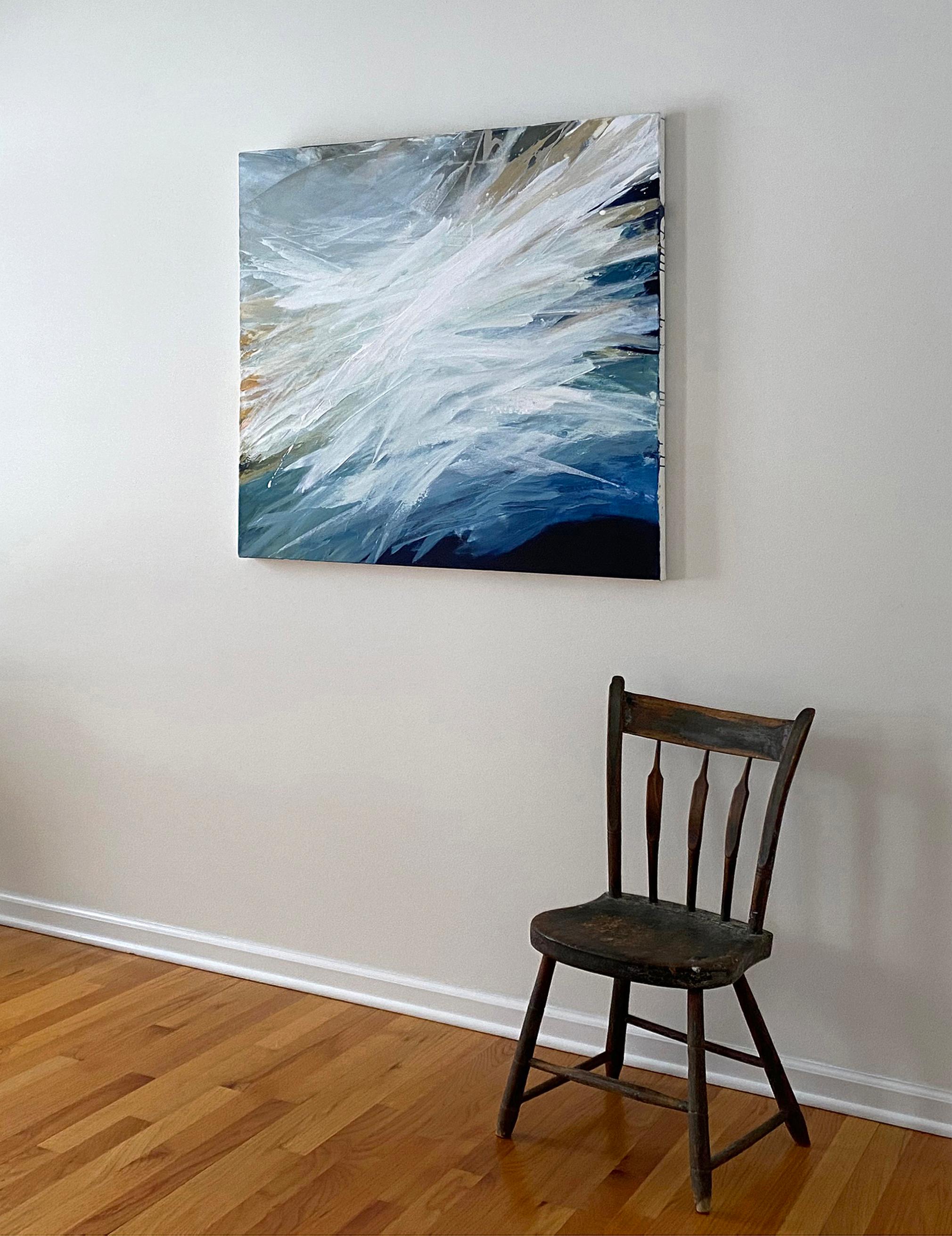 This contemporary abstract painting by Teodora Guererra is made with acrylic paint on gallery wrapped canvas. It features a cool palette, with varying tones of blue layered over top of one another, and warm yellow ochre accents throughout. Large
