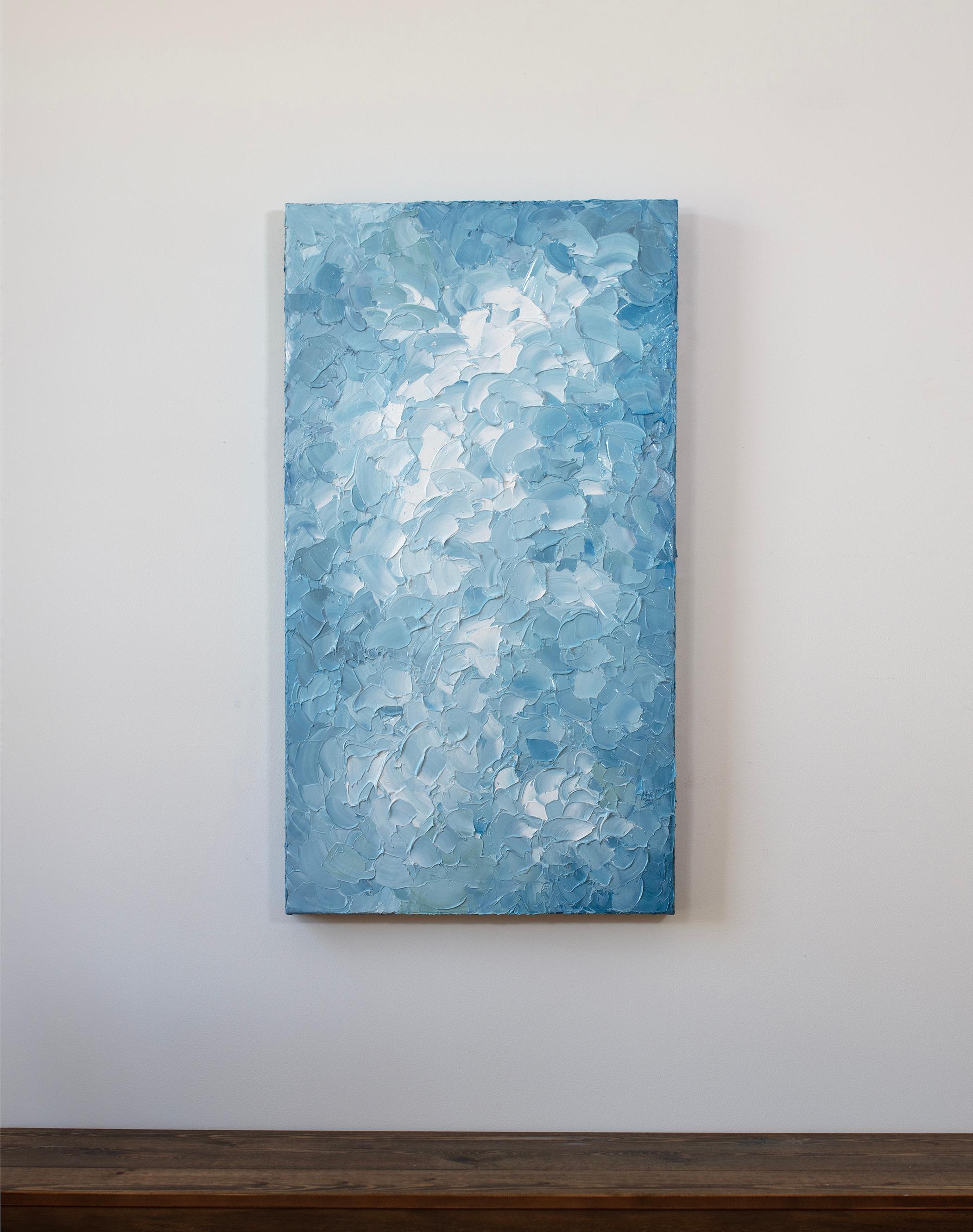 This textured abstract painting by Teodora Guererra features a light blue and white palette. The artist applies thick layers of paint in short, sweeping gestures - a process she likens to frosting a cake. The painting is made with oil paint on