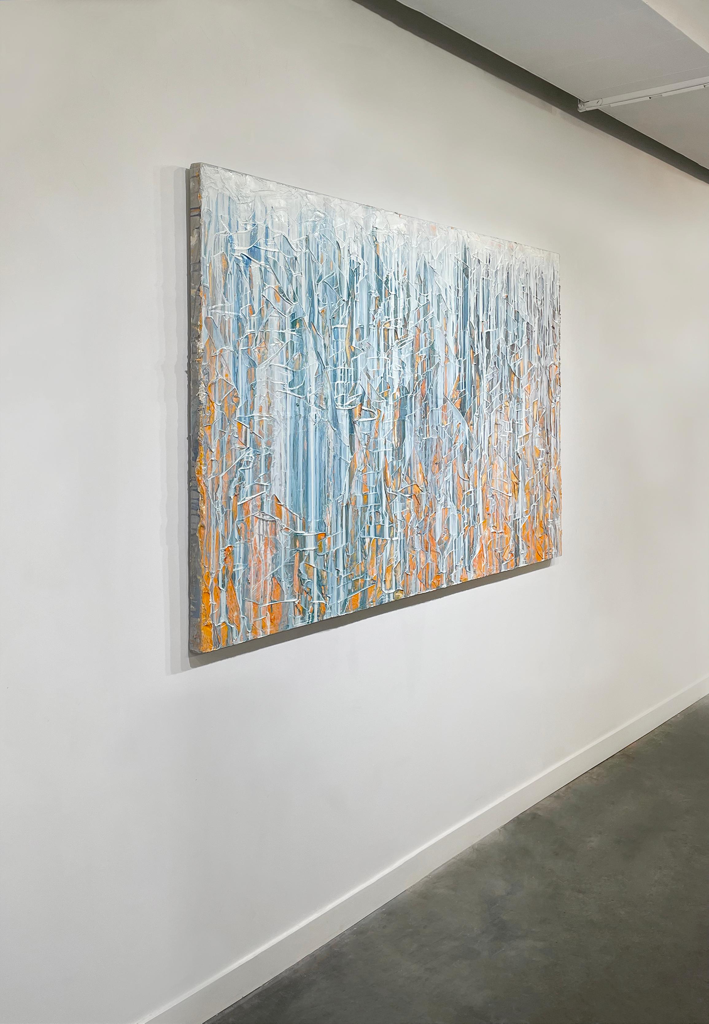 This large-scale, abstract statement painting was created with oil paint on gallery wrapped canvas. Thick drips of white and grey blue paint are dripped down the front of a sculptured palette knifed surface. The textured under layer consists of a