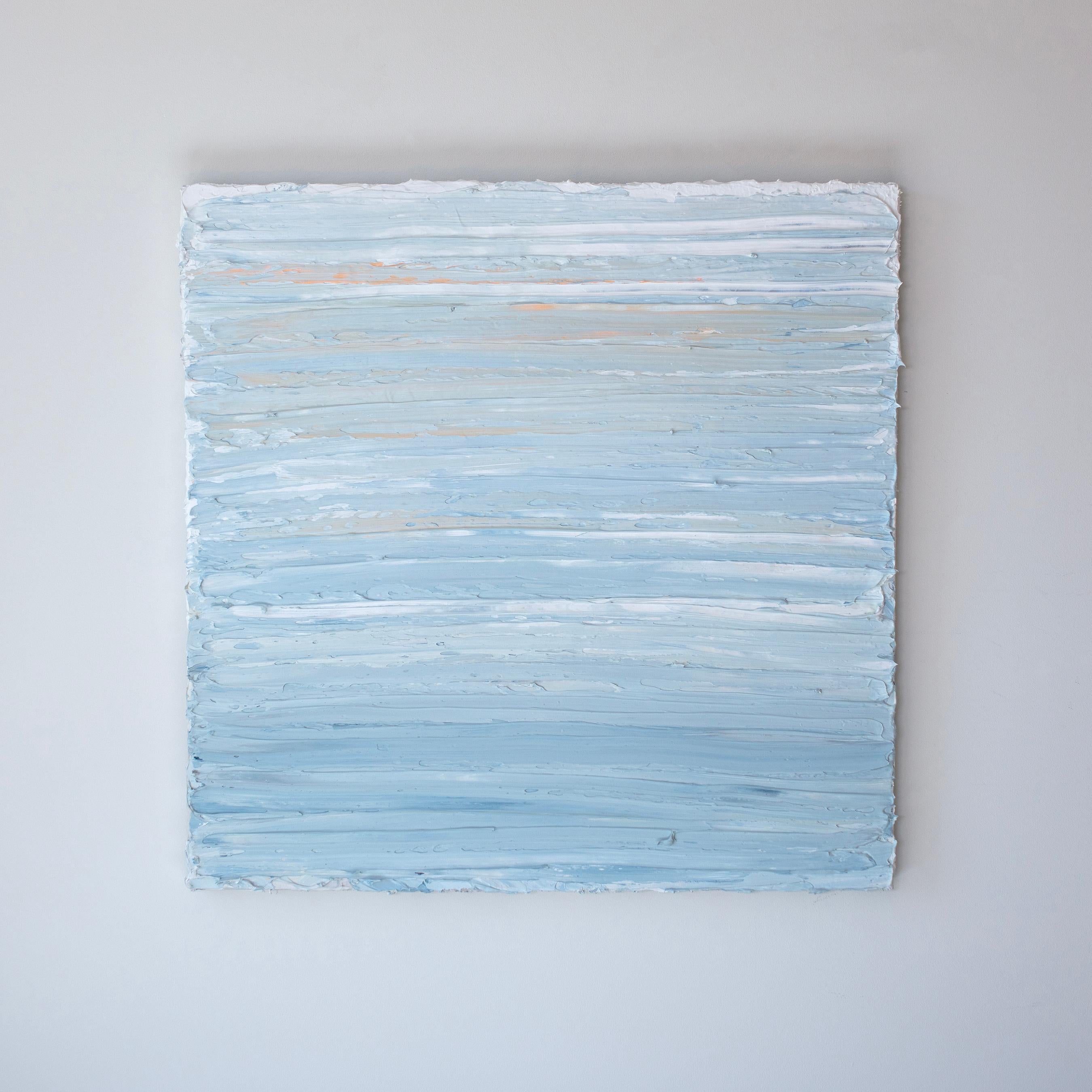This abstract painting by Teodora Guererra features a light, cool palette of blue and white with subtle orange accents at the top of the composition. The artist applies thick layers of oil paint in wide, horizontal gestures to create a thick, highly