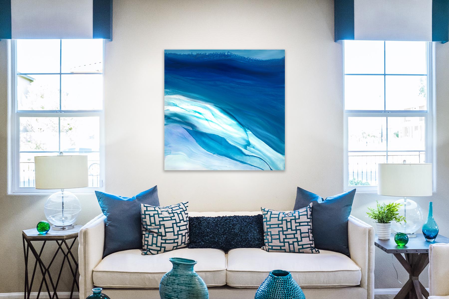 This abstract coastal painting by Teodora Guererra features a cool blue, teal, and turquoise palette. The artist applies washes of color that blend together to create an abstract composition with coastal elements. The painting is wired and ready to