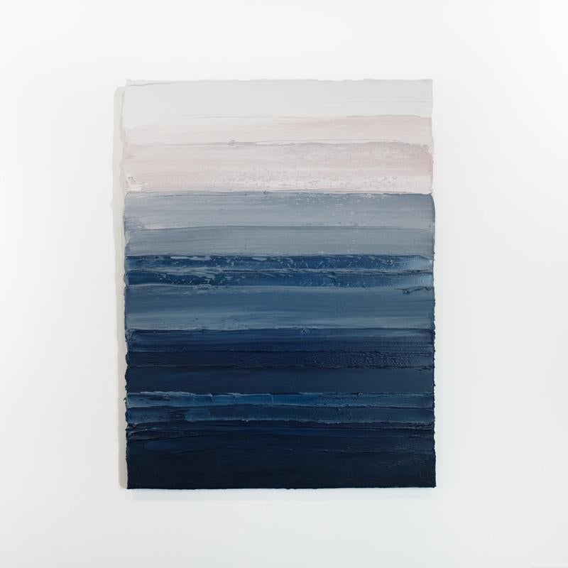 This abstract painting by Teodora Guererra features deep blue palette which fades to mid-tone blue, grey, and white at the top of the canvas. The artist layers thick horizontal strokes of paint using a palette knife in broad, sweeping strokes over