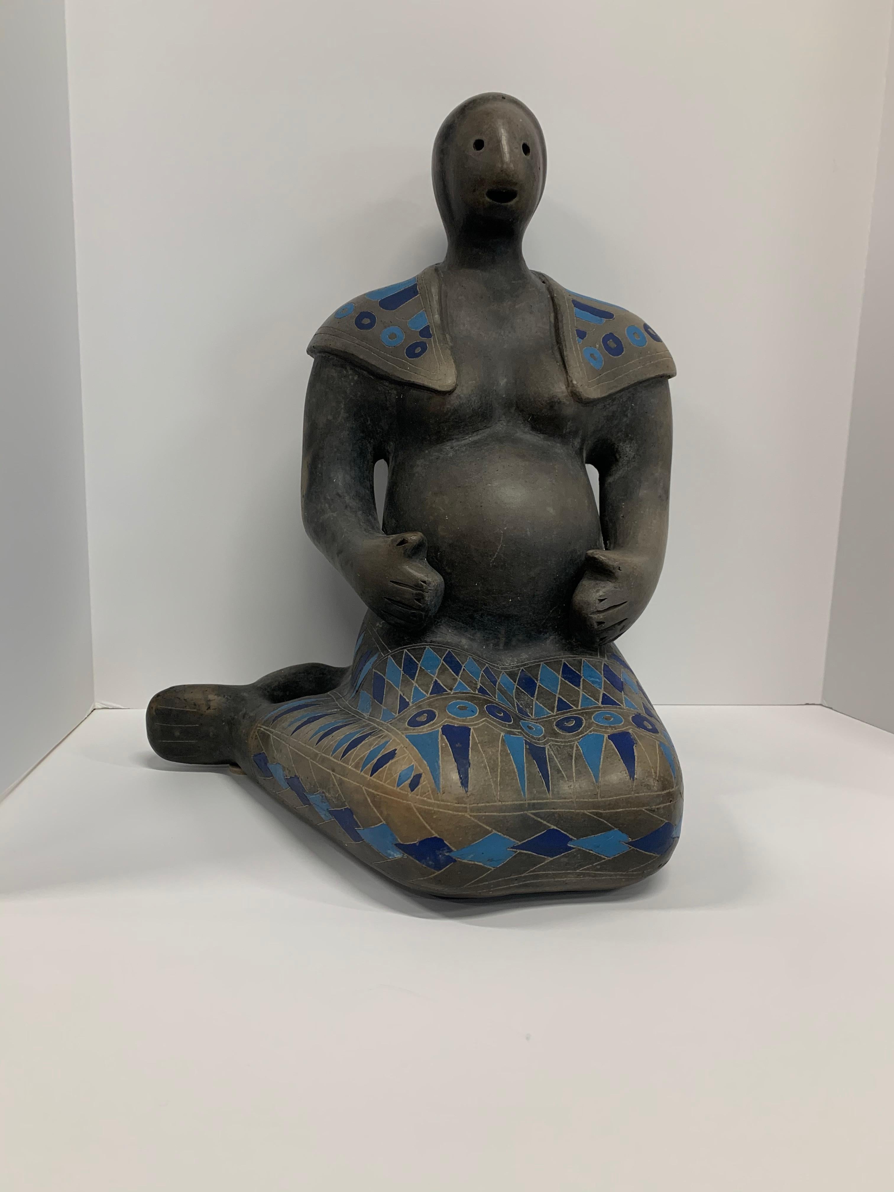 A feritilty figure likely by Max Kerlow from Teotihuacan in Mexico. Depicting a pregnant woman decorated in bright blue triangles. In good condition with minor flaws. Approximately 14 1/2 inches tall.