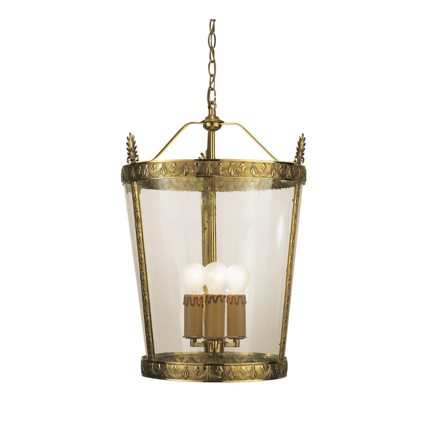 This exquisite lantern is made in bronze with a sophisticated French gold finish. Its simple lines designing a conic shape are covered in transparent glass and the bronze structure is artfully enriched by engravings throughout. A precious addition