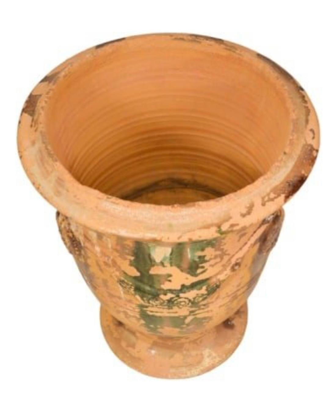 A 20th century terracotta Anduze pot in a medium size with distressed glaze. 