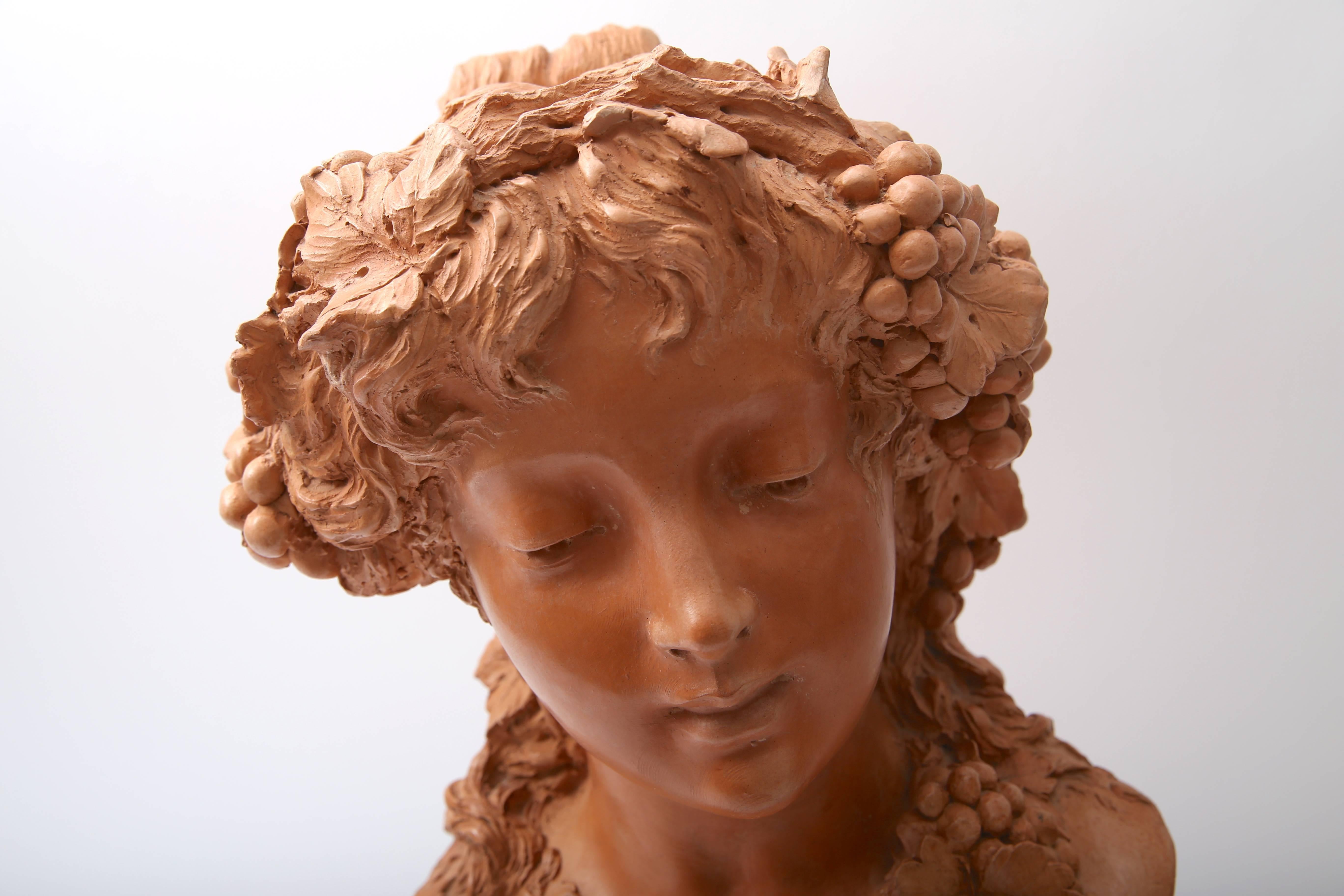 This stylish terracotta bust has a sensuality and fluidity of the Art Nouveau period in France.

Note: Base dimensions are 5.75