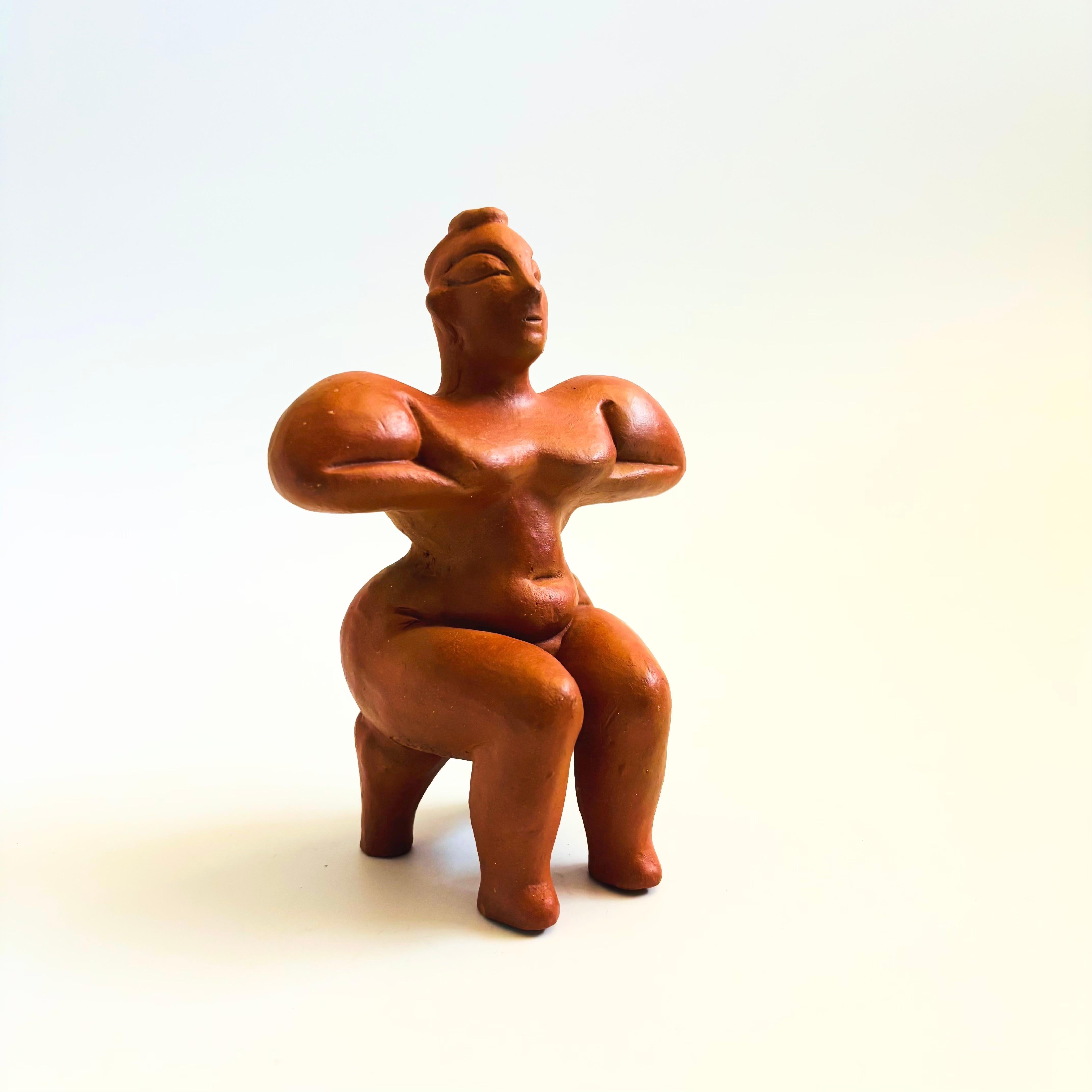 A vintage terra cotta pottery figurative sculpture of a seated fertility goddess. Made in Kula, Turkey by replica artist S. Askit and marked on the base.

