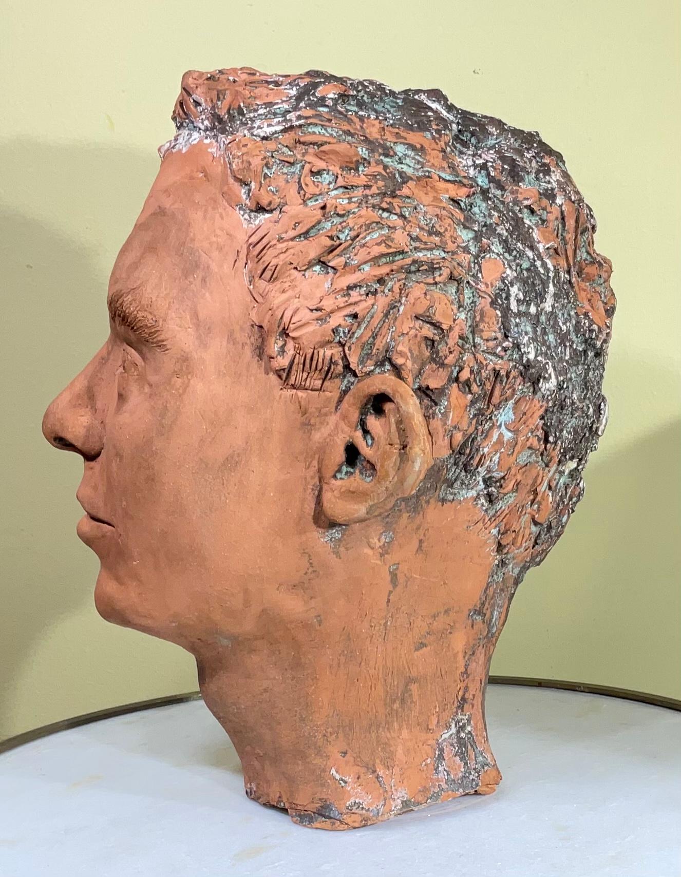 Intriguing bust of a young man made of rustic unglazed terra-cotta great eyes expression, looking forward.
Beautiful object of art for display.

