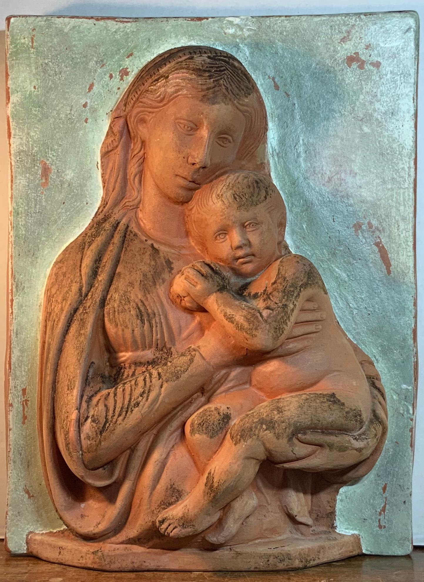 Beautiful sculpture made of terracotta, of mother and her child, hand painted background
and weathered patina, could hang on the wall indoor or outdoor or just could stand by itself over the fireplace.
Great object of art for display.