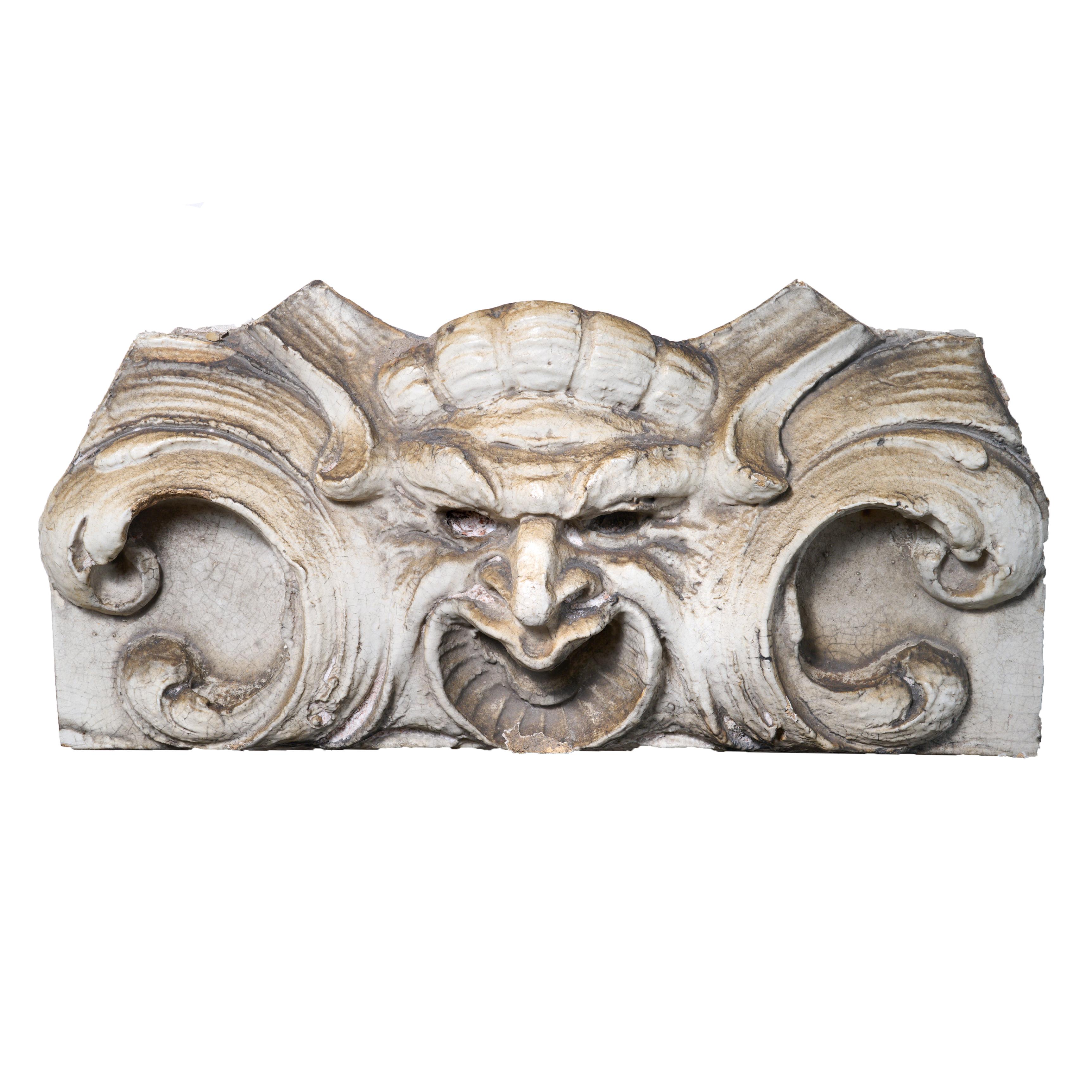 Terra cotta mascaron from a building facade with newly made custom wall mount.

