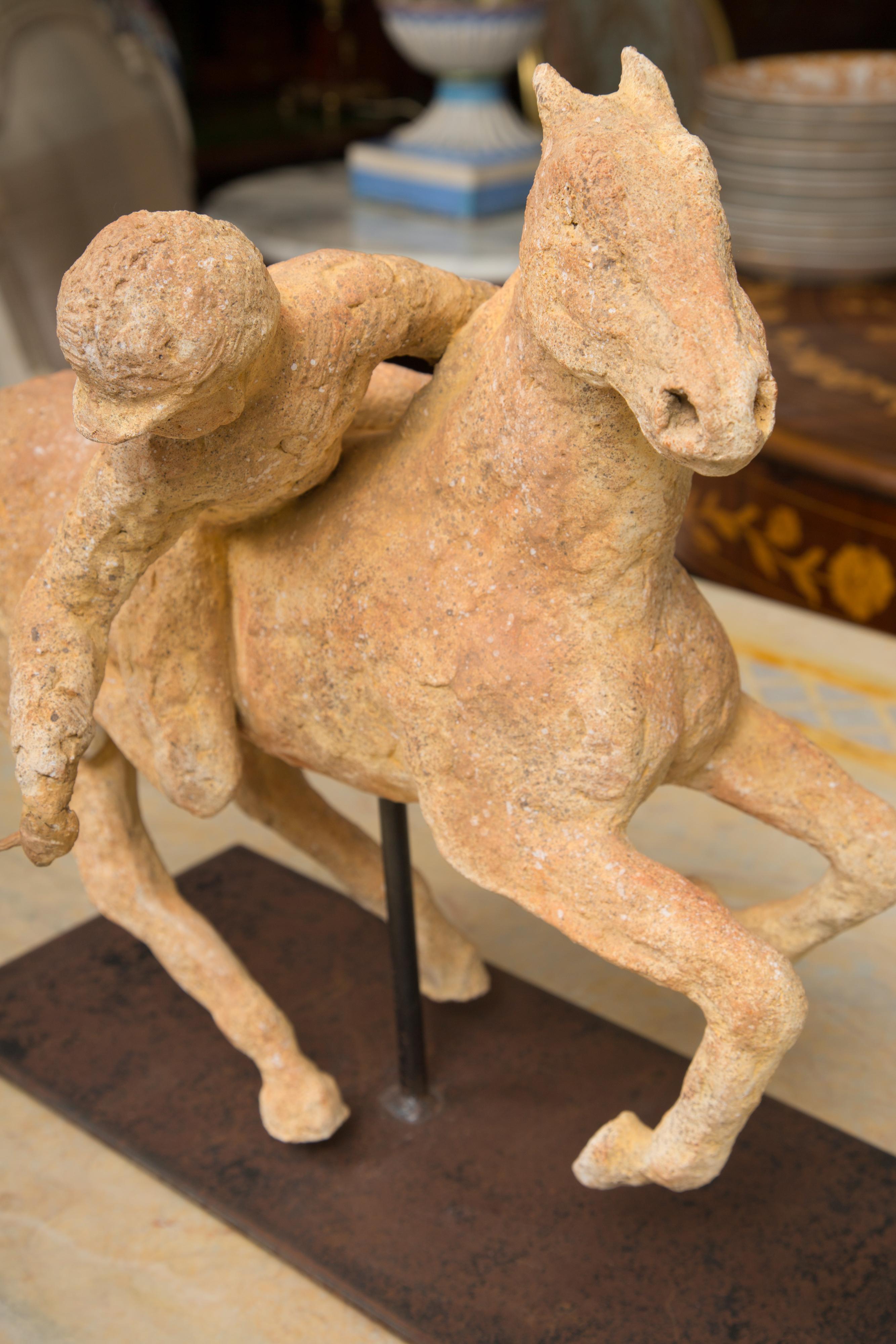 Terracotta Polo Player on a horse mounted on a Metal Stand by 