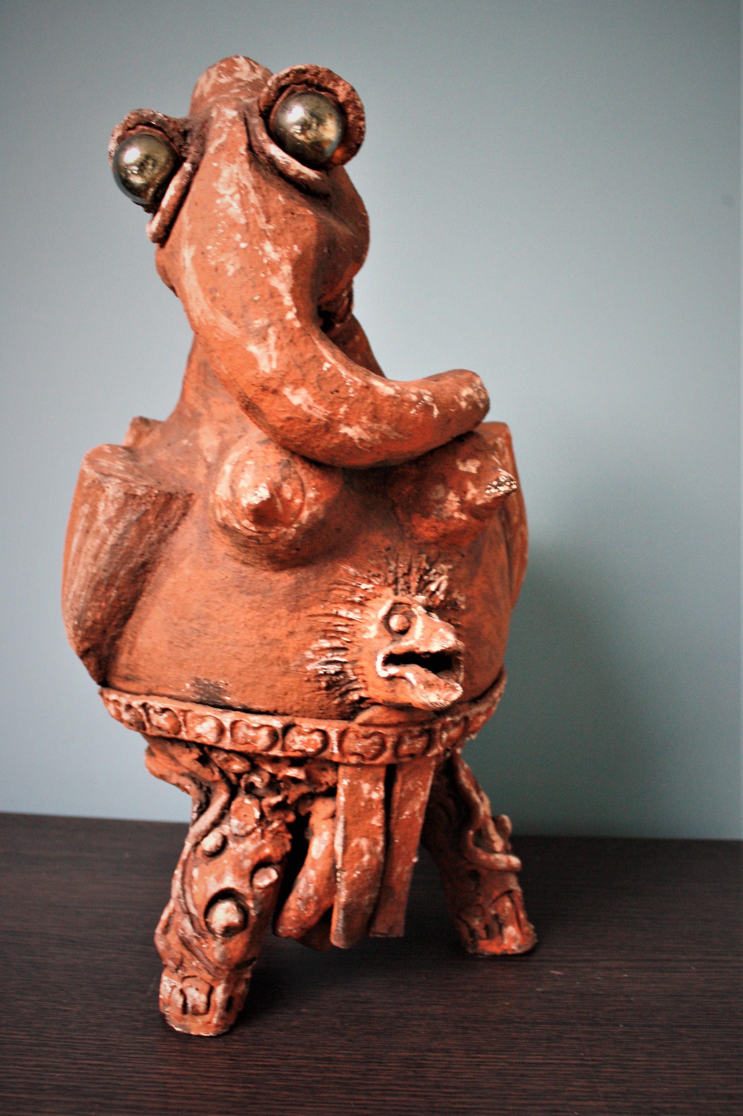 Unusual post demonic or alien-like sculpture in terracotta by Belgian artist Michel Hereman.

He was known for making such strange sculptures which were sold in multiple art galleries in Belgium.

We bought this one without any knowledge and by
