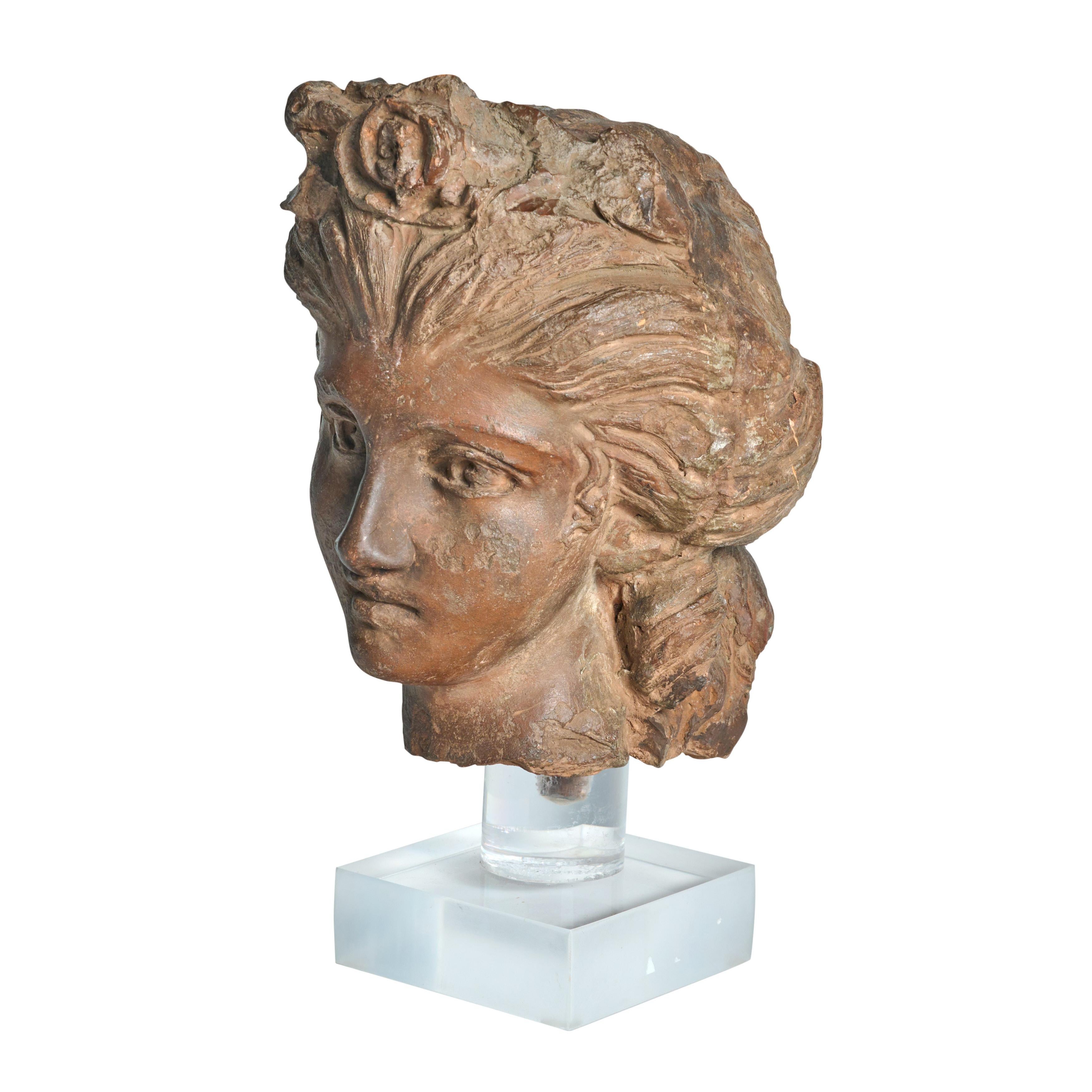 Fragment from a terra cotta statue depicting a classic women’s head. Great condition. Custom lucite stand is newly made.
