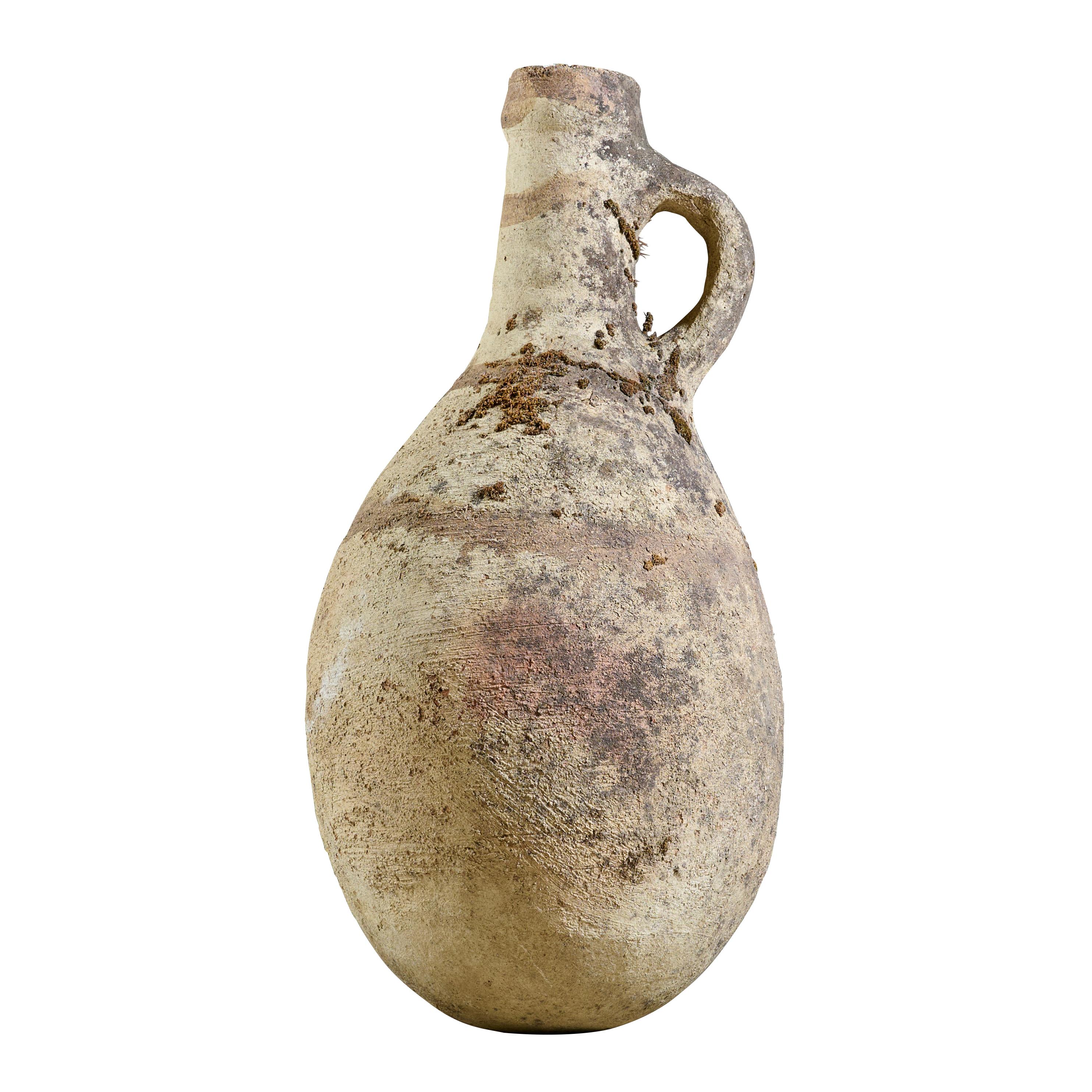 Terra cotta wine vessel with wonderful handle and great patina.

