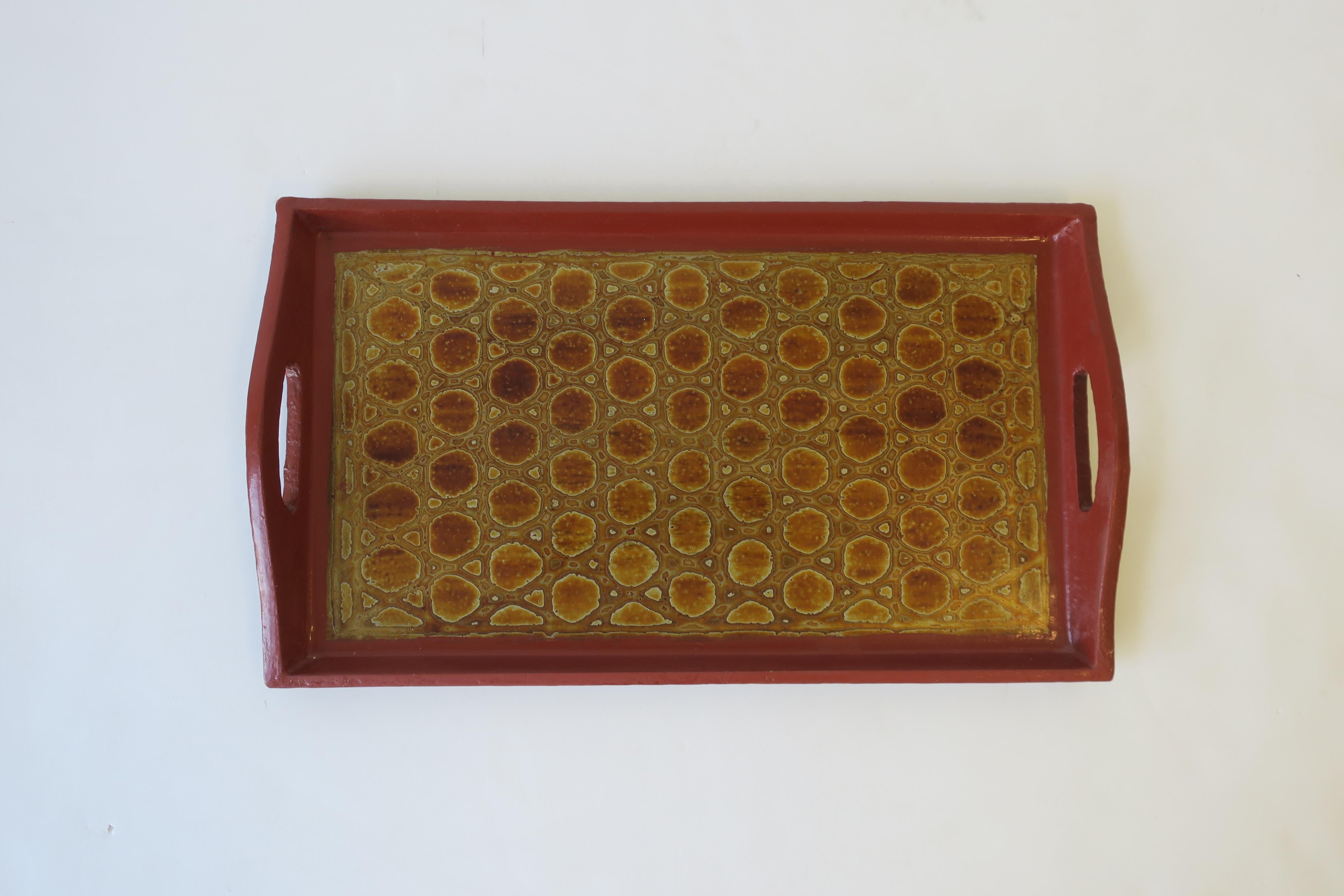 A chic red burgundy terracotta, gold and black lacquer rectangular serving tray with handles. Tray has a gold iridescence reptile (crocodile or alligator) like design.

Piece measures: 8.38