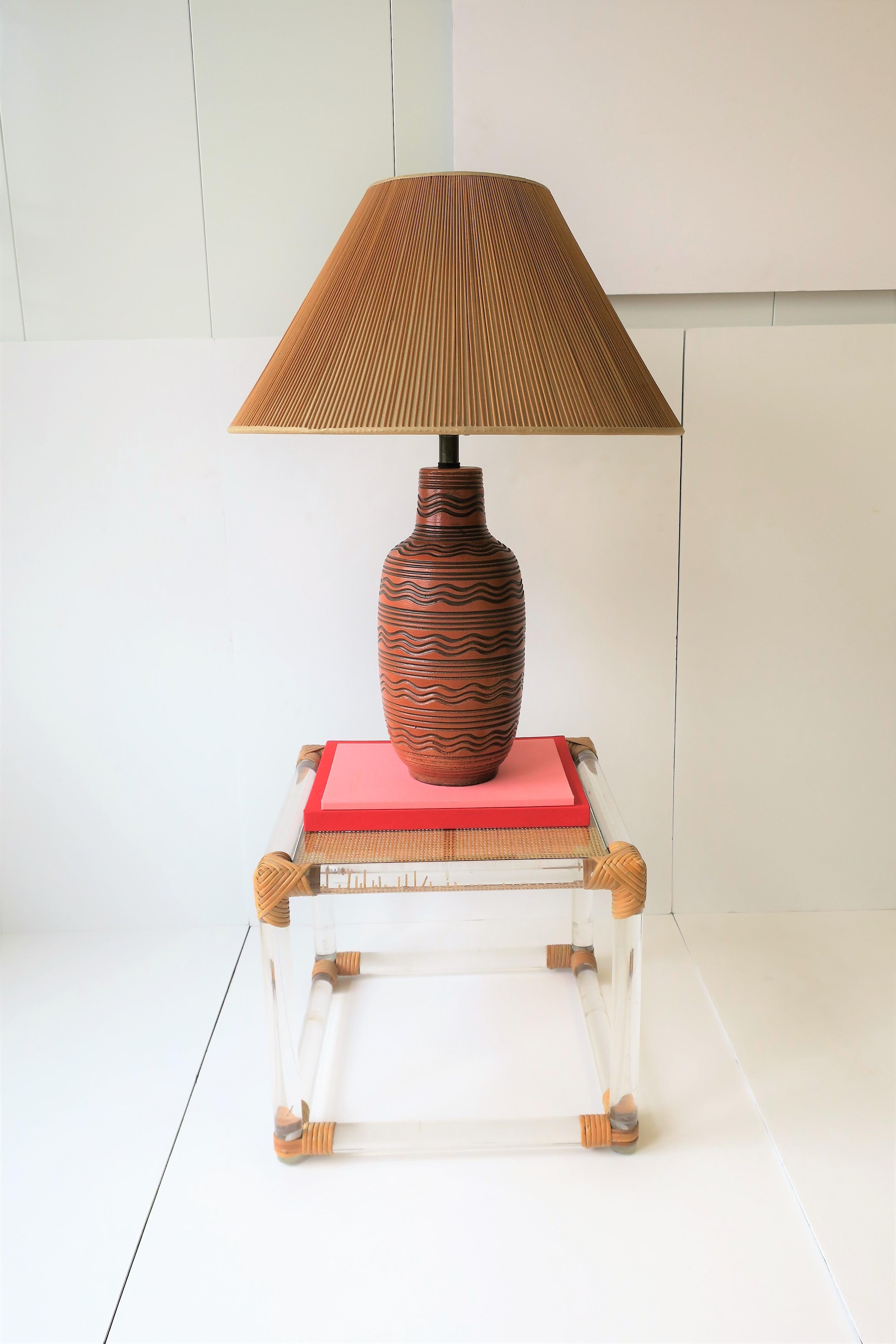 A very beautiful terracotta and black pottery desk or table lamp by Design Technics, circa mid-20th century. 

Lamp measurements: 
29