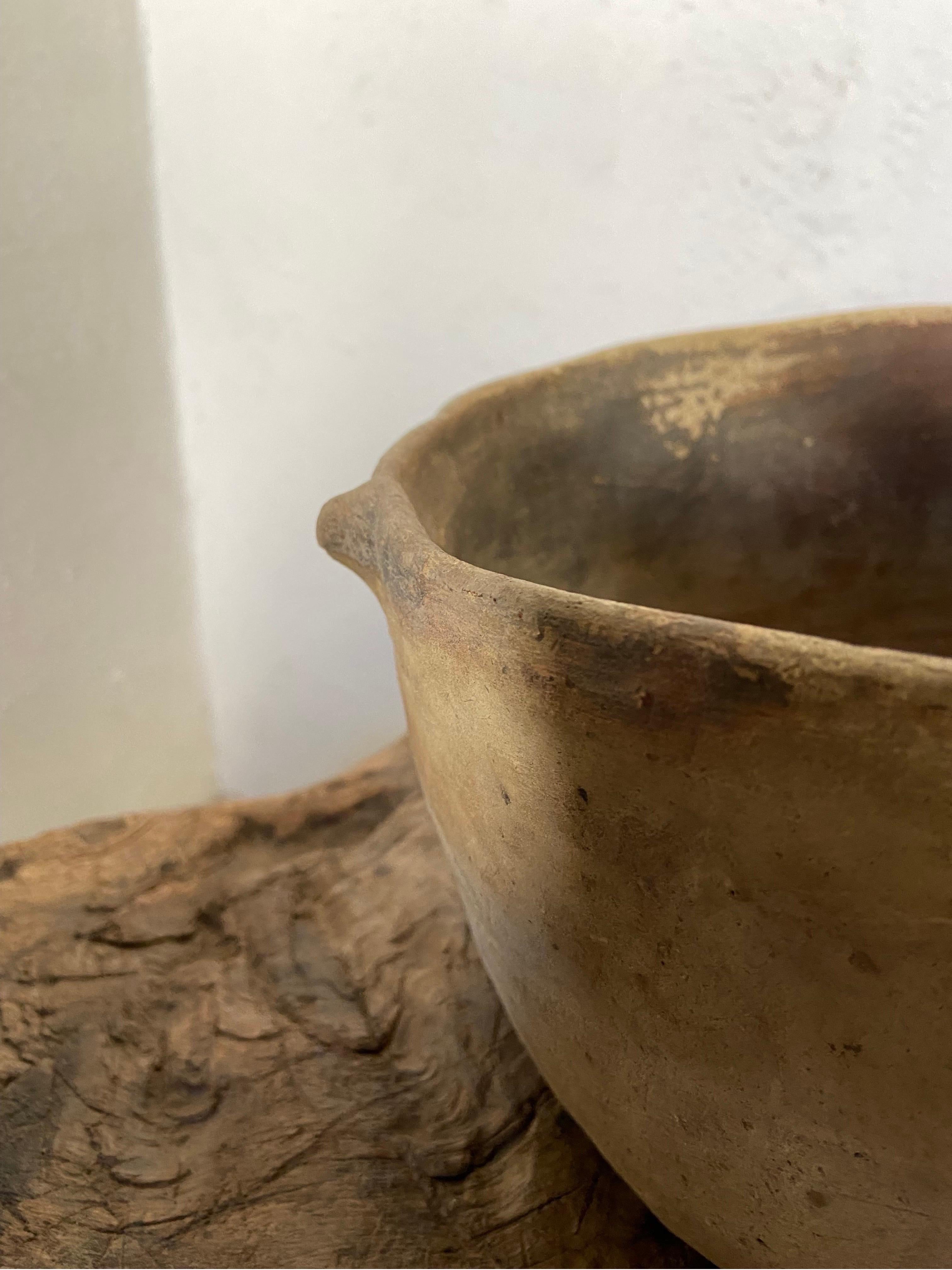 a terracotta bowl artifact has a triangular pattern