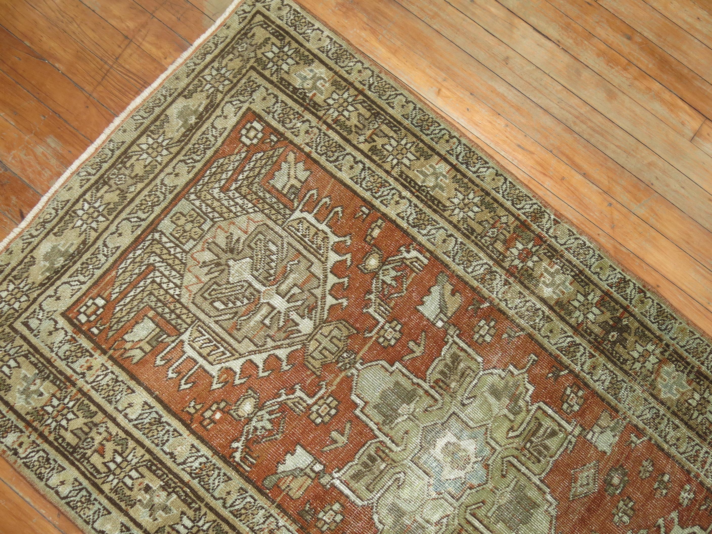 Decorative Persian Heriz one of a kind antique runner from the early 20th century. Large scale medallions hover over a terracotta field, accents in cocoa and green

Measures: 2'9” x 11'5”.