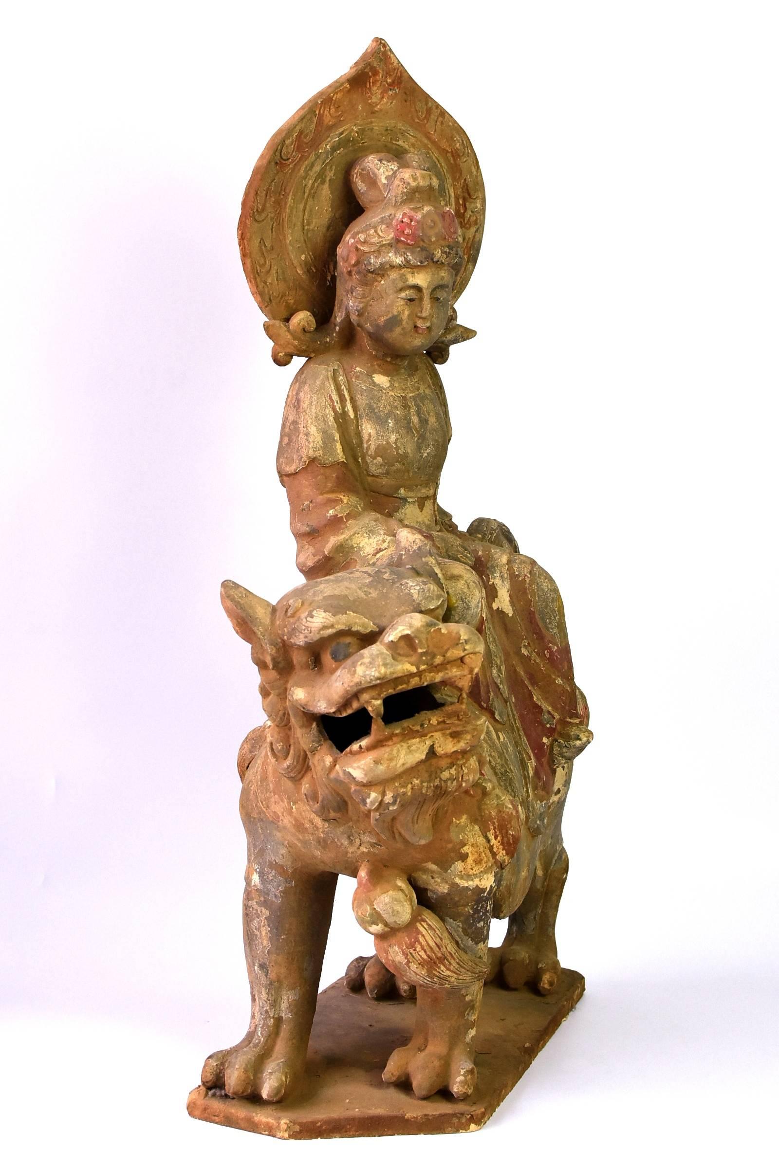 A fantastic terracotta piece featuring Bodhisattva Wen Shu on her lion ride. Wen Shu, one of the four great Bodhisattva, is The Bodhisattva of Wisdom, with the particular quality representing deep understanding of life's philosophy and power to
