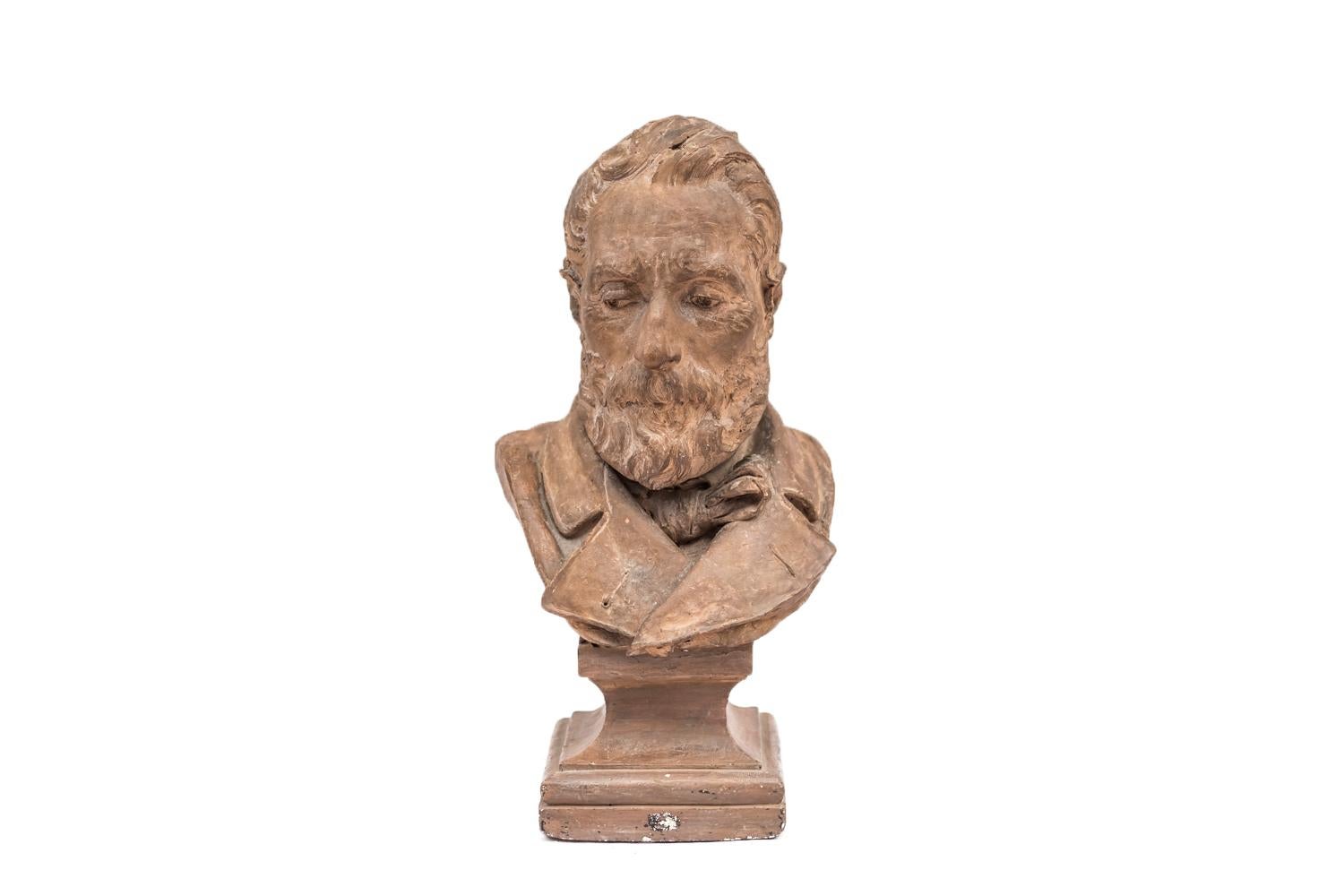 A. Fabre, signed.

Terracotta bust figuring an old and bearded man. He wears a 19th century style jacket and a scarf around his neck.
He stands on a piedestal and a square base.

Signed “A.FABRE” and dated 1878 on the back bust.

Work