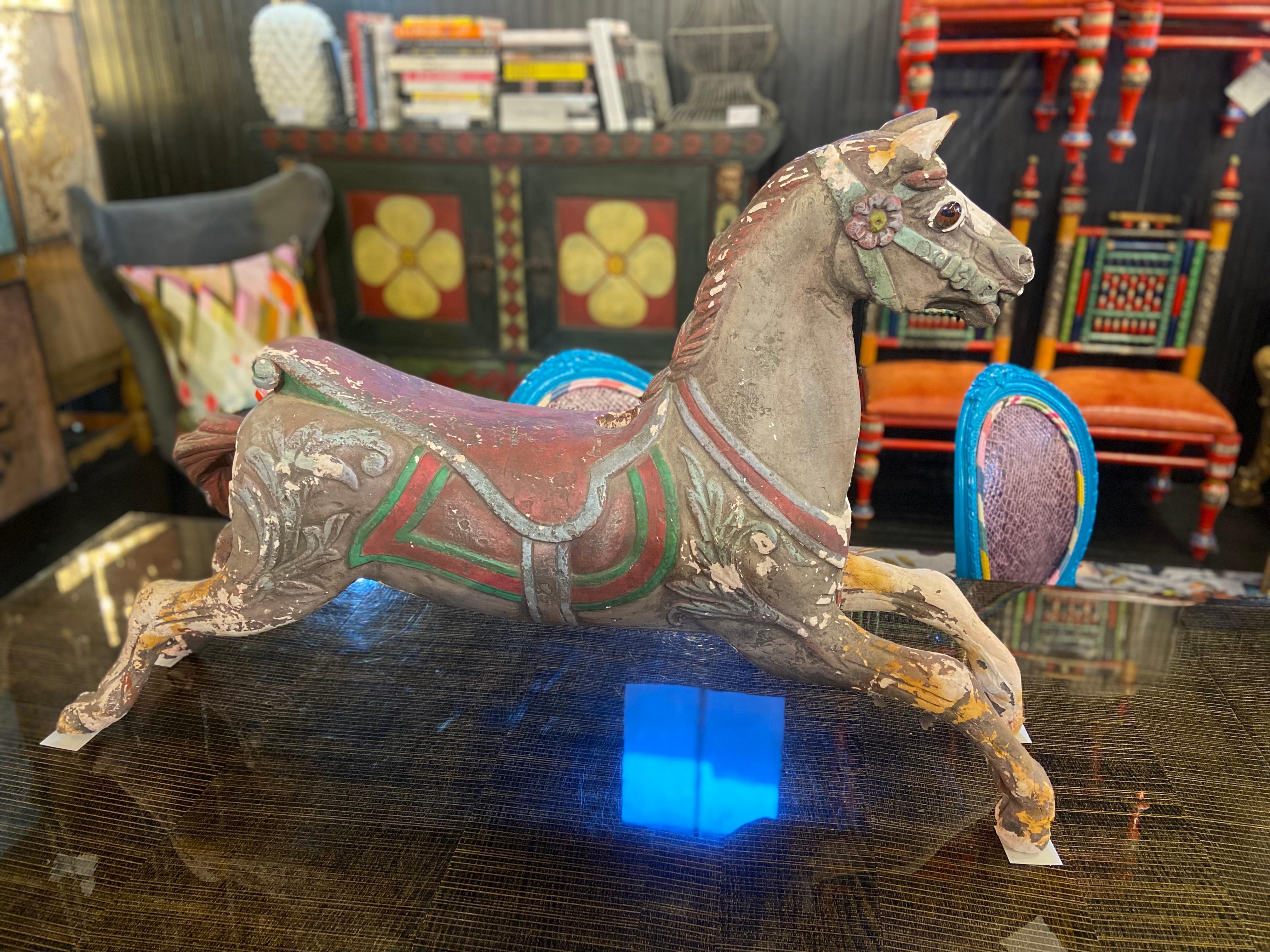 Offering you the exclusive opportunity to own a captivating antique carousel horse (1 of 2), straight from the enchanting world of a children's carousel. These magnificent treasures are crafted from terracotta, boasting their original vibrant paint