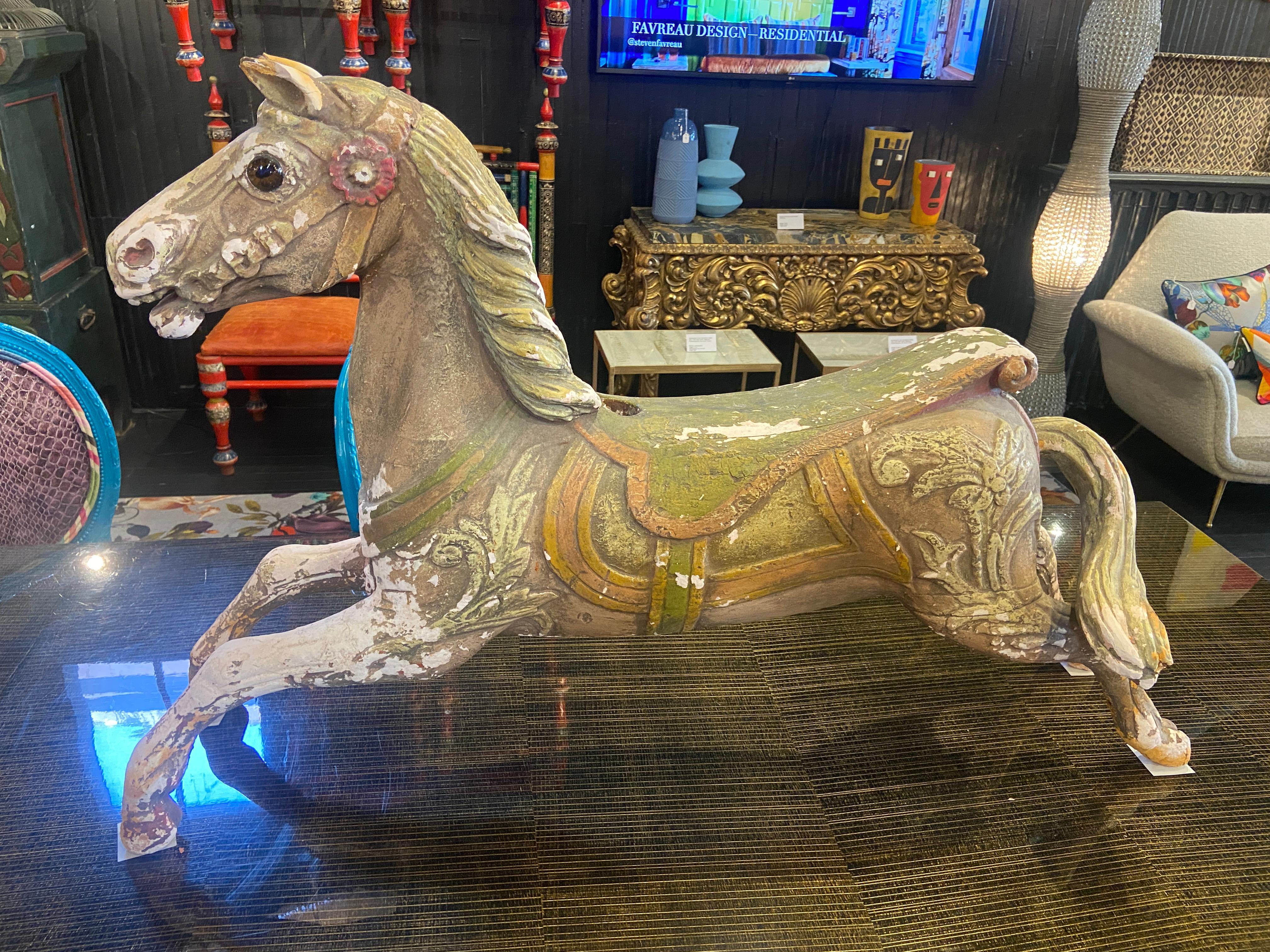 Offering you the exclusive opportunity to own a captivating antique carousel horse (2 of 2), straight from the enchanting world of a children's carousel. These magnificent treasures are crafted from terracotta, boasting their original vibrant paint
