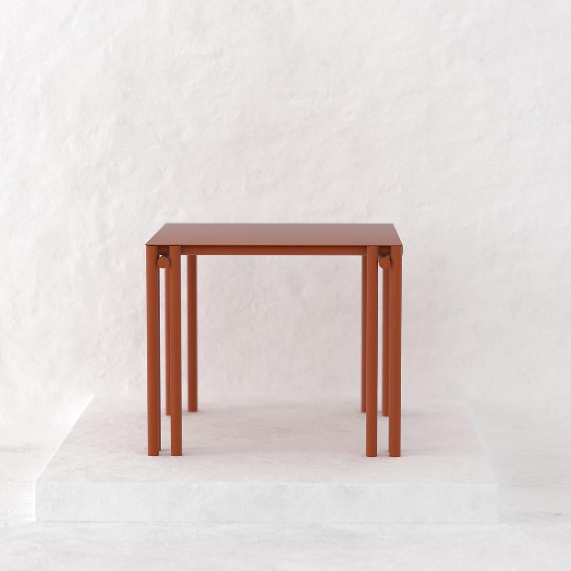 The Dolmen Square Dining Table is a tubular piece conceptualized as a dining table suitable for both, indoor and outdoor. 
Crafted by hand in metal and coated with a matte electrostatic finish its size can be customized.
With a table top of  90 x 90