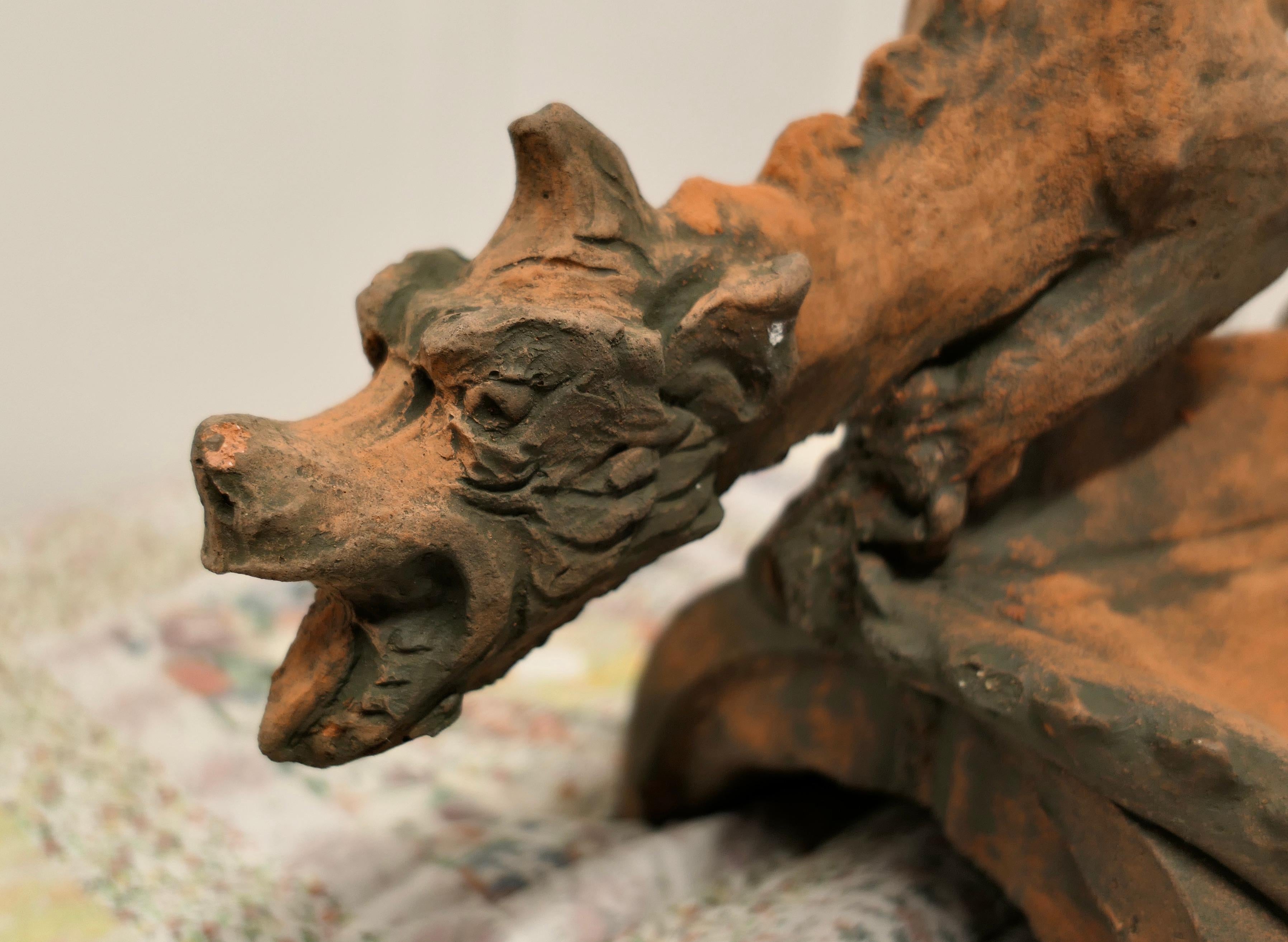 Terracotta Dragon Roof Ridge Finial 

This fearsome finial has a lovely weathered patina and it is a really great decorative pieces
The Dragon is in good sound condition the underside has no cement or other adhesive on show so I think it has never