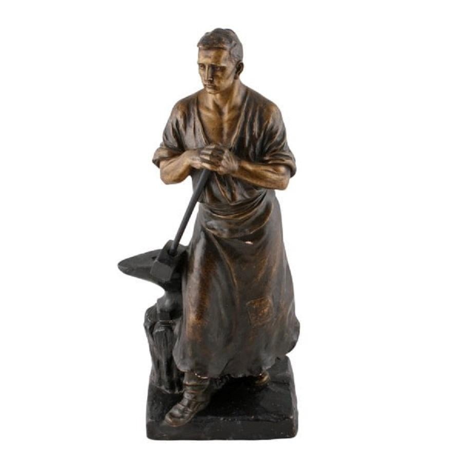 A late 19th to early 20th century terracotta figure of a blacksmith with a hammer and anvil.

The figure has an indistinct maker's mark impressed in the back and the number 803.

The terracotta has a bronzed finish and a black base, the shaft of