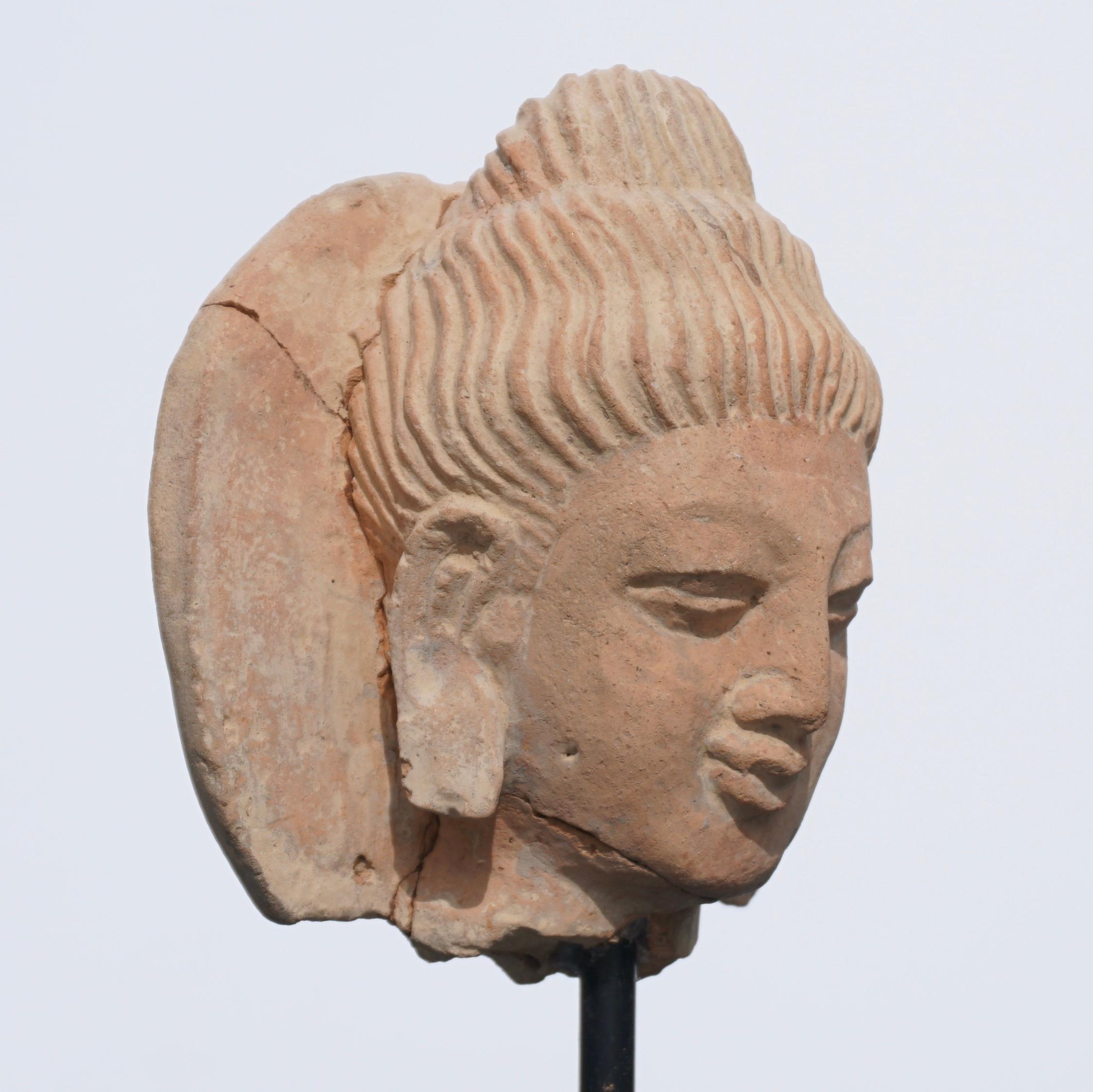 A terracotta Gandhara Buddha head.

One of the oldest Buddhas in the world. Buddha was first portrayed by Greek artists in the 2nd century in Gandhara Afghanistan/Pakistan. First especially in stone (schist) but as the demand rose, one also worked
