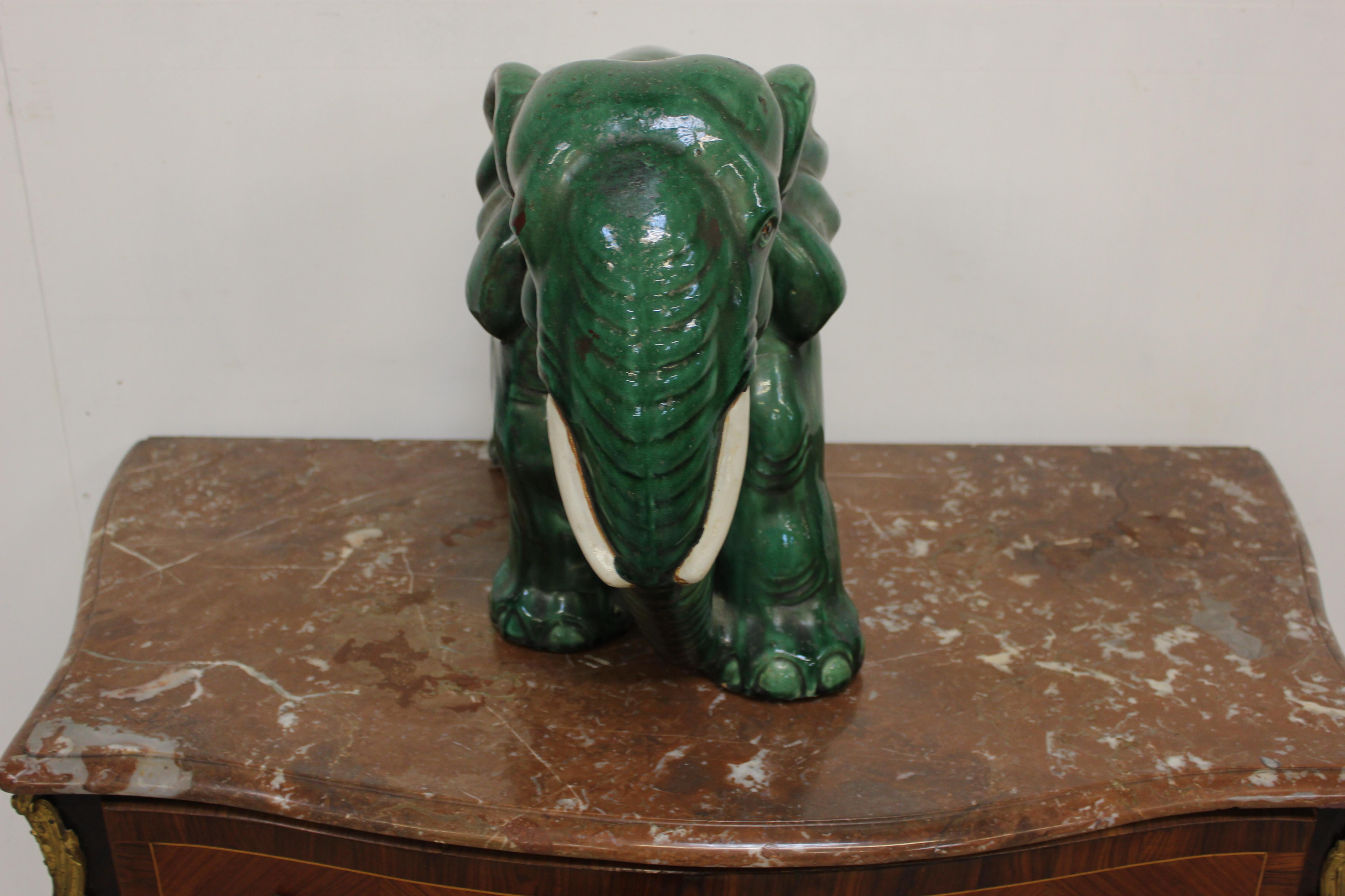 A terracotta green glazed elephant has a very nice look. I have had a look online to try and find something to compare it to but cannot find anything it came from a very good estate, a wonderful rich jade green color.