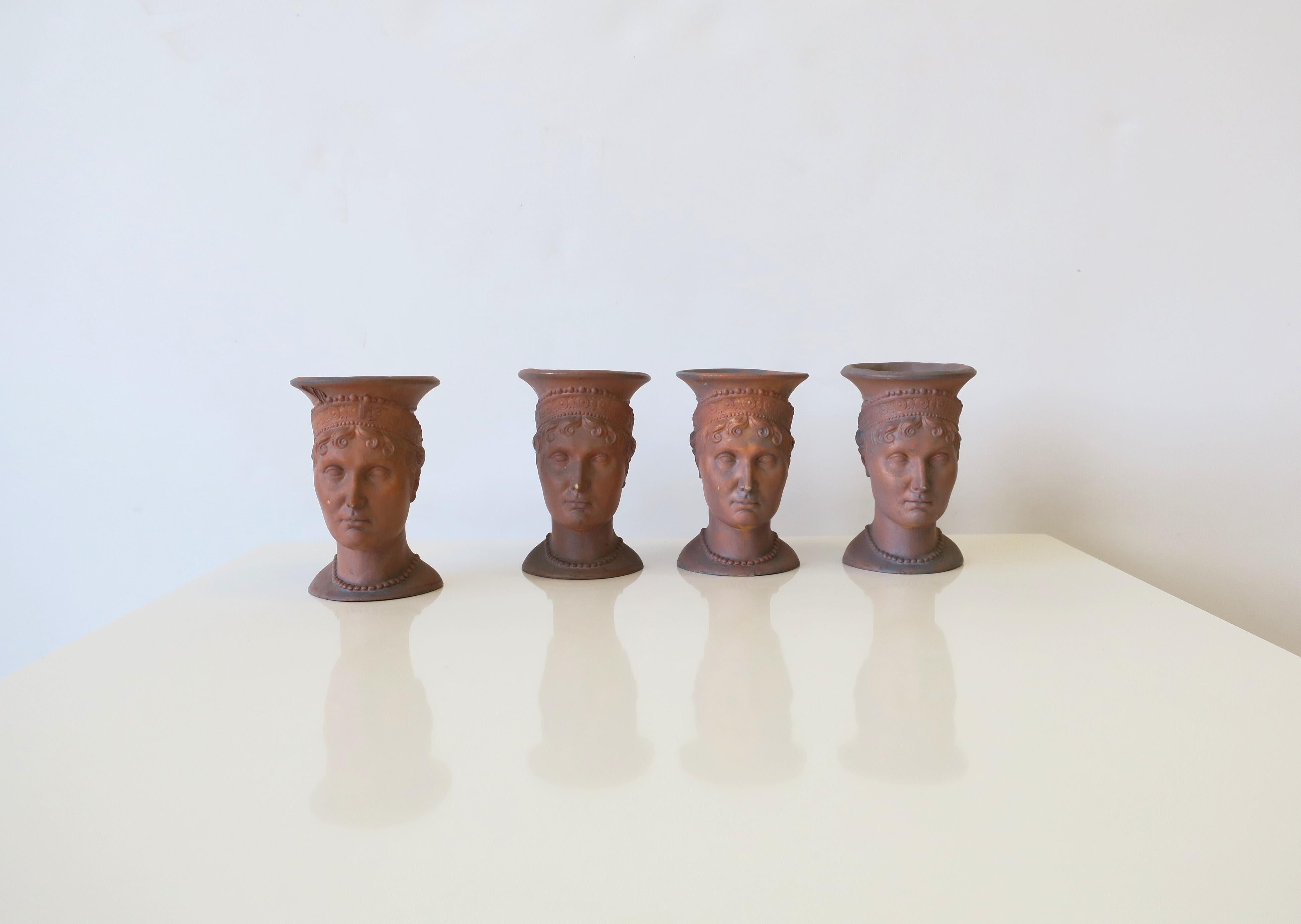 A beautiful set of four (4) terracotta head bust sculptures. Four female head sculpture carvings glazed in terracotta. Beautiful decorative objects as demonstrated. A signature appears on the inside edge of one as shown in image #19. 

Dimensions: