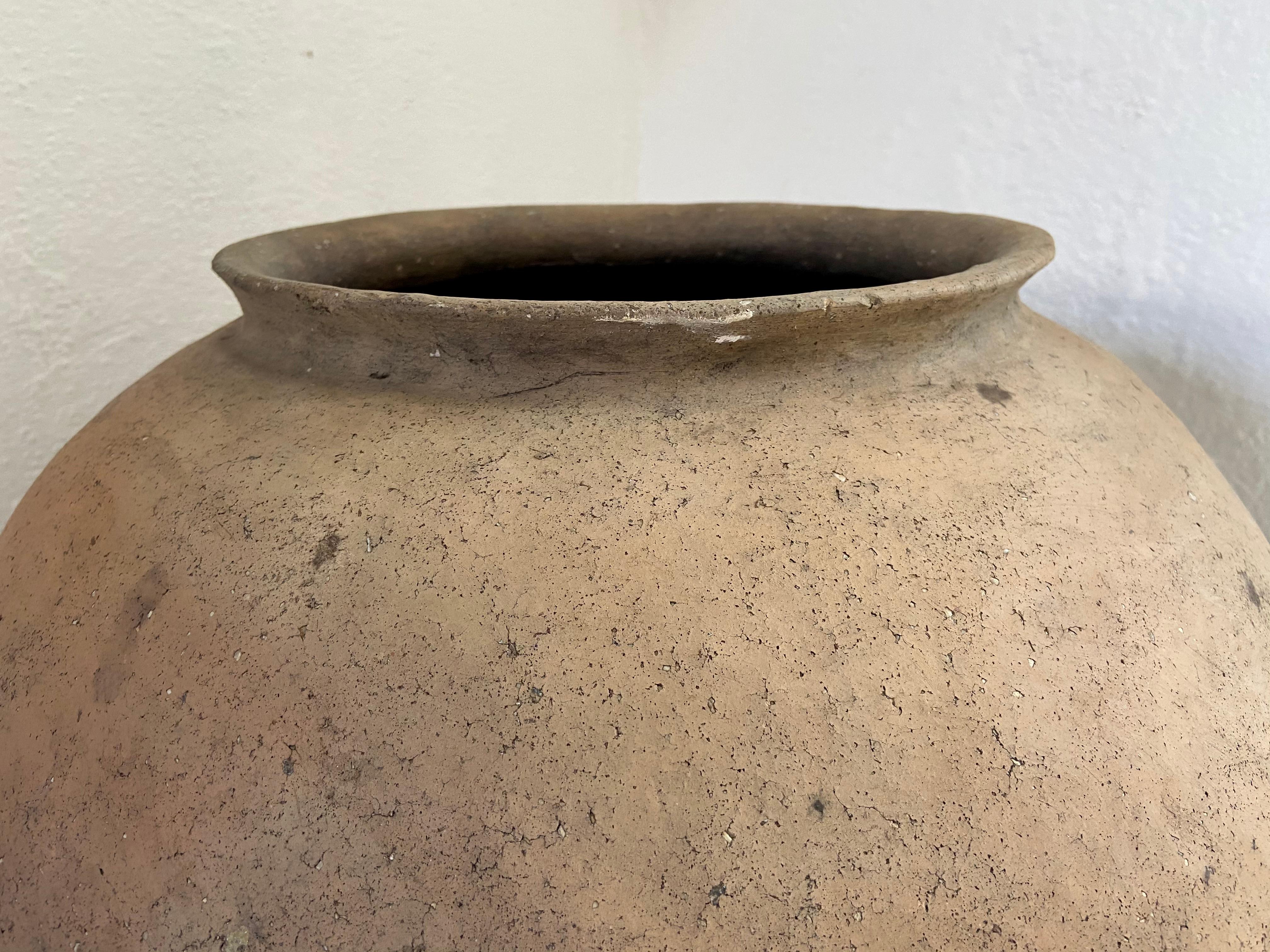 Terracotta water pot from the northern highlands of Puebla, Mexico. Both handles are intact and the pot is structurally solid.