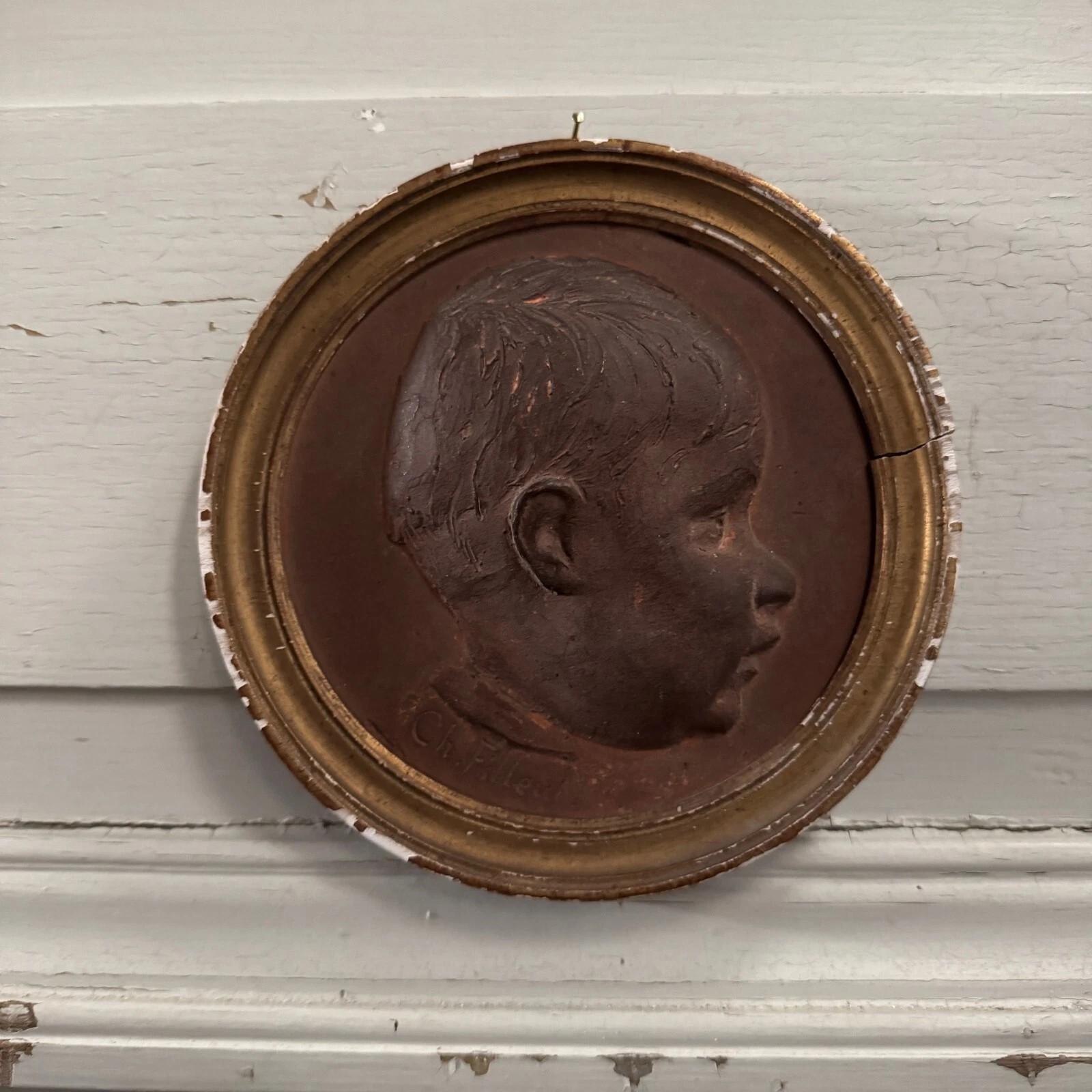 Français Terracotta medallion by Charles Filleul – Profile of a young boy, 20th century. en vente