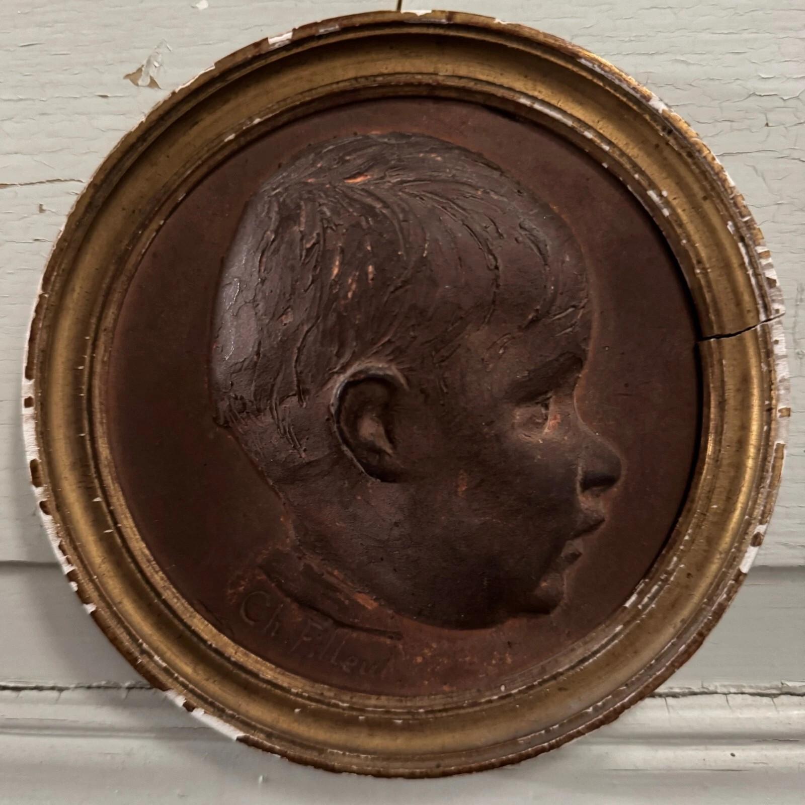 Sculpté à la main Terracotta medallion by Charles Filleul – Profile of a young boy, 20th century. en vente