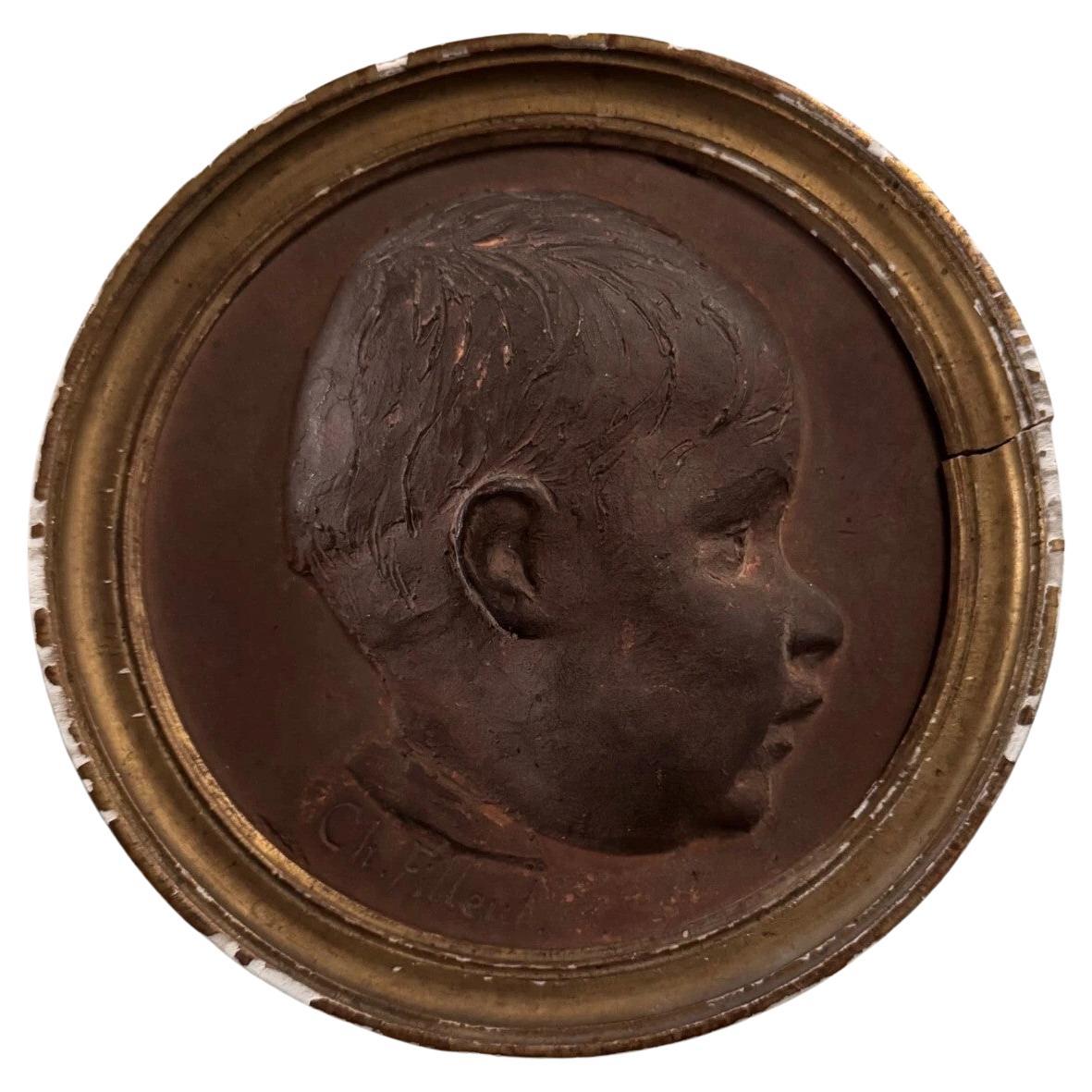 Terracotta medallion by Charles Filleul – Profile of a young boy, 20th century. en vente