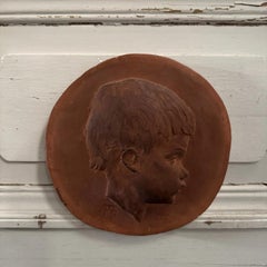 Terracotta medallion by Charles Filleul – Profile of a young child, 20th century