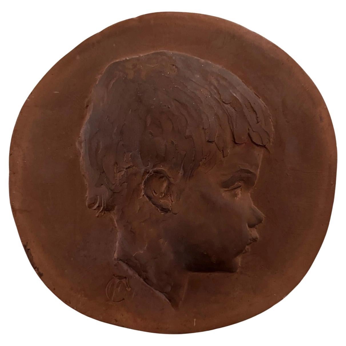 Terracotta medallion by Charles Filleul – Profile of a young child, 20th century