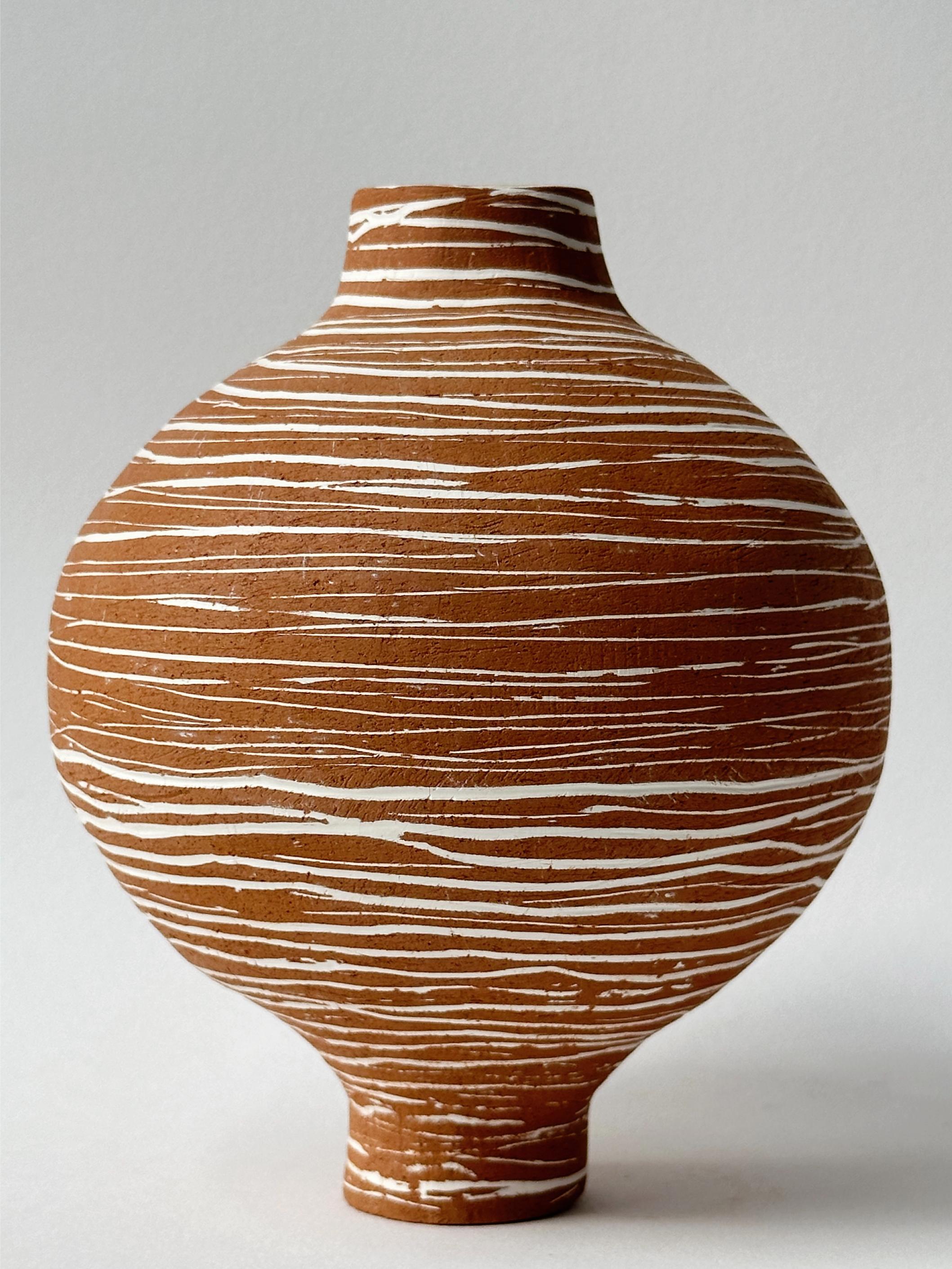 Terracotta Moon Jar No 13 by Elena Vasilantonaki
Unique
Dimensions: ⌀ 13.5 x H 16.5 cm (Dimensions may vary)
Materials: Local Terracotta Clay from the Island of
Crete

Growing up in Greece I was surrounded by pottery forms that have changed little
